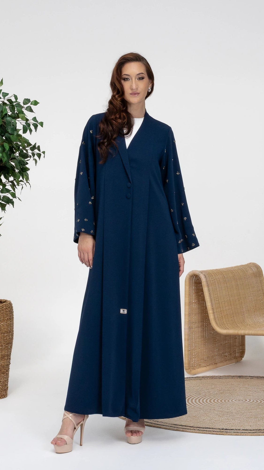 NUJUMA Midnight Luxe modest luxury abaya featuring celestial gold embellishments on sleeves