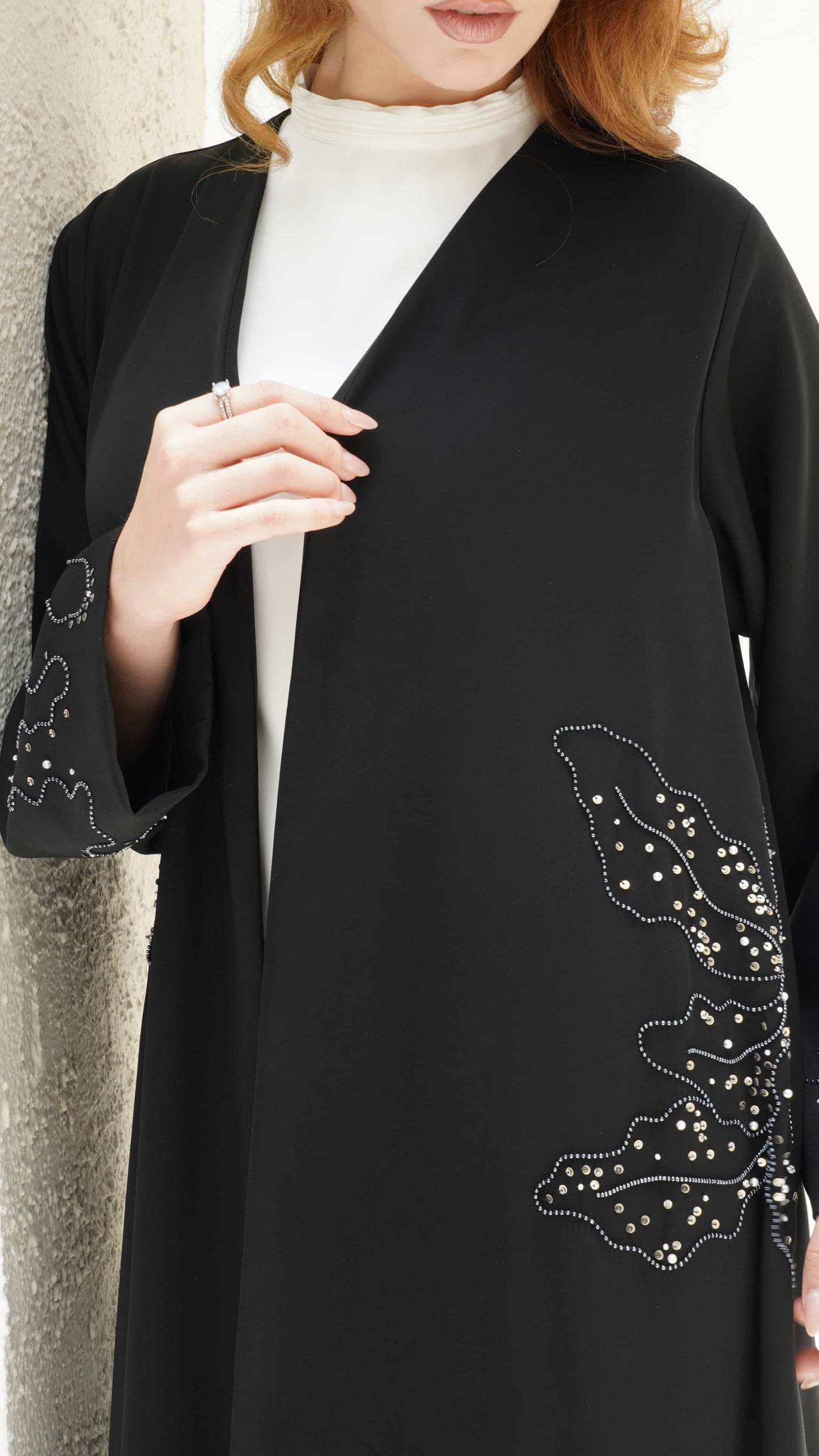 AZIZA | Noir Fleur Close up of floral silver beadwork detail on sleeve of Aziza abaya 