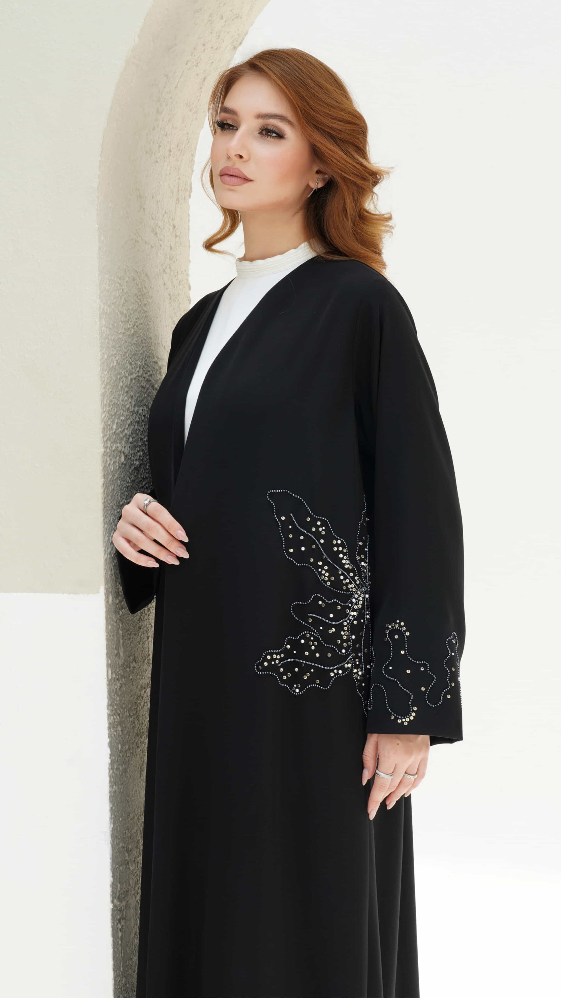 AZIZA | Noir Fleur Side view of black abaya highlighting floral beadwork along waist panel