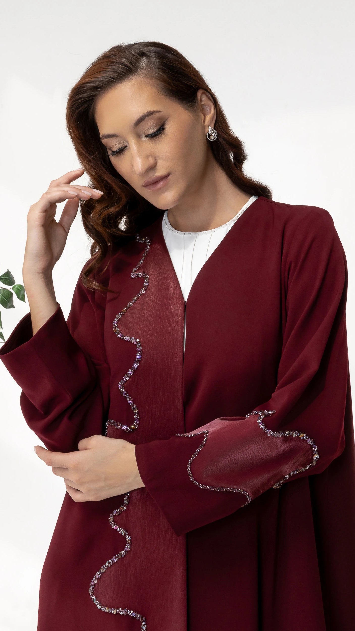 Close-up portrait of BARIQAH Mulberry Luxe abaya highlighting crystal wave detailing and premium craftsmanship