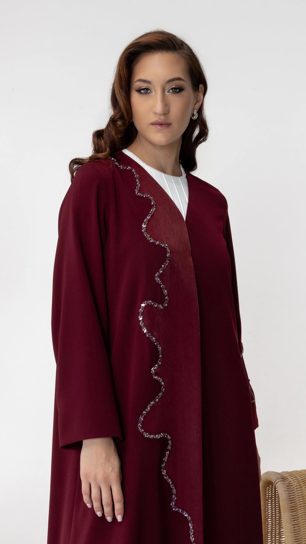 Side pose of BARIQAH Mulberry Luxe abaya featuring couture crystal wave embroidery and fluid drape