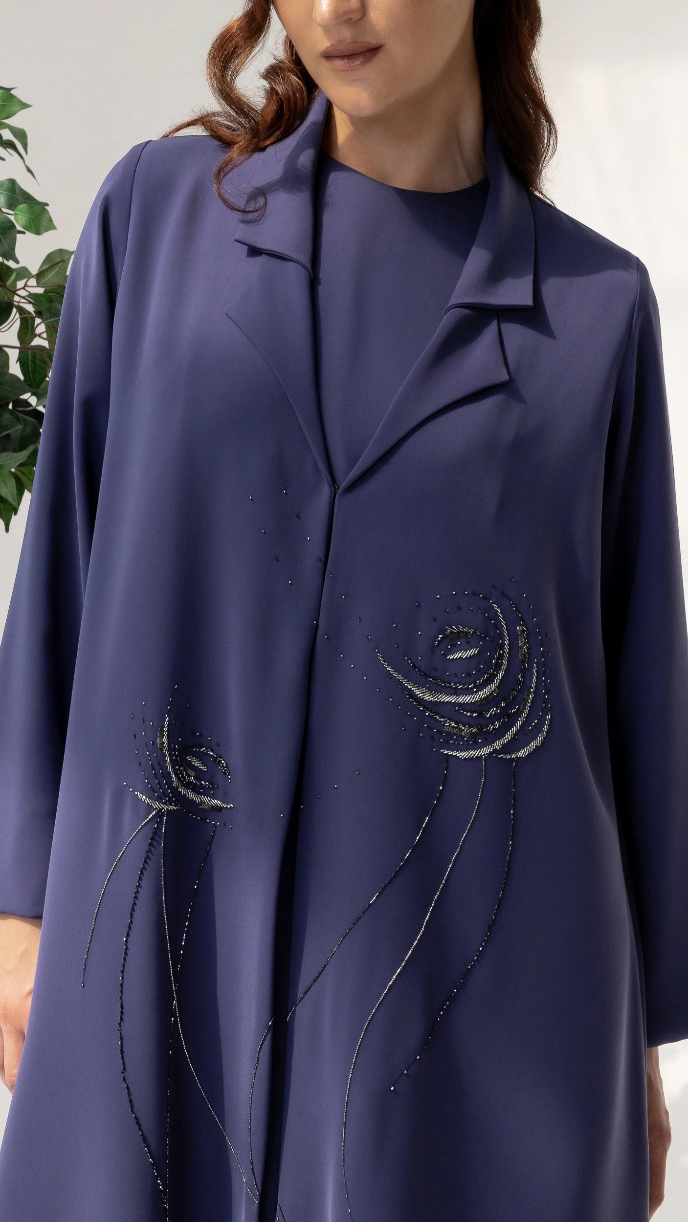 Detailed close-up of DAHANA Violet Bloom luxury abaya featuring premium crystal floral artistry and refined tailoring