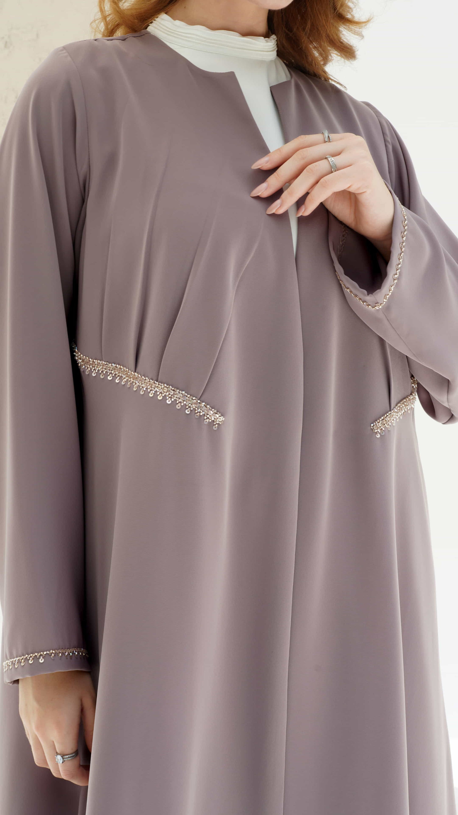 DOUNIA | Blush Aura Front detailing and Sleeve detail with fine shimmer trim on luxury blush abaya and gentle pleates