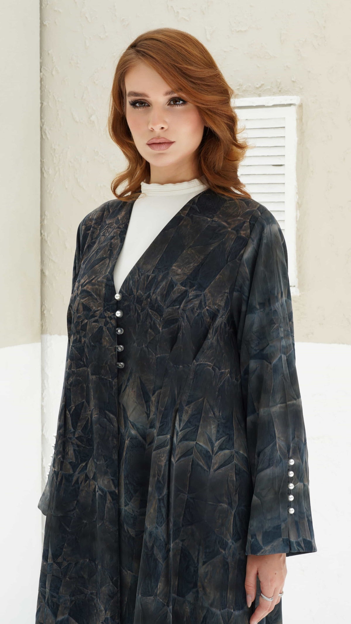 FAIZA | Midnight Mirage Close-up of Faiza abaya showing pearl buttons and abstract fabric detailing