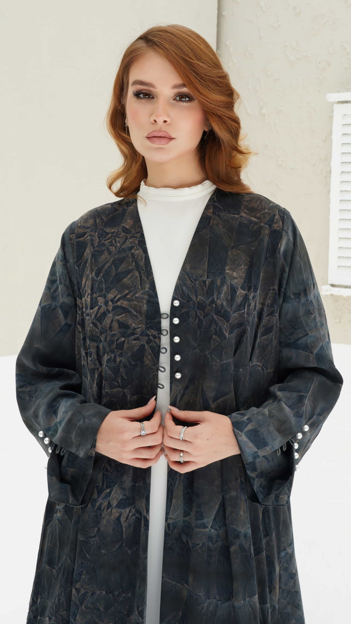 FAIZA | Midnight Mirage Front pose of Faiza abaya highlighting sleeve pearl buttons and soft flowing structure