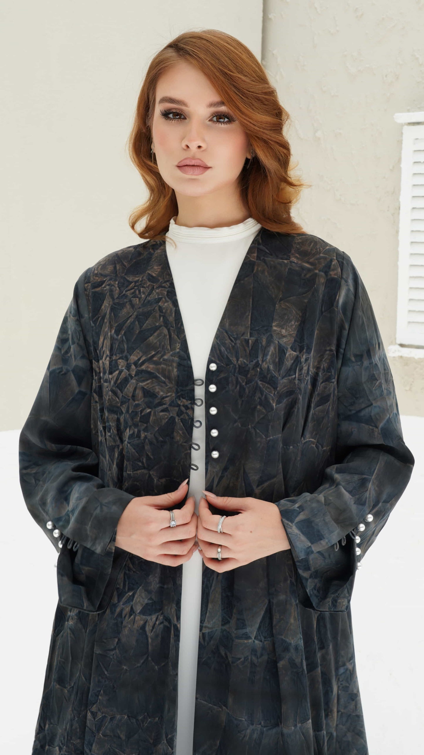 FAIZA | Midnight Mirage Front pose of Faiza abaya highlighting sleeve pearl buttons and soft flowing structure