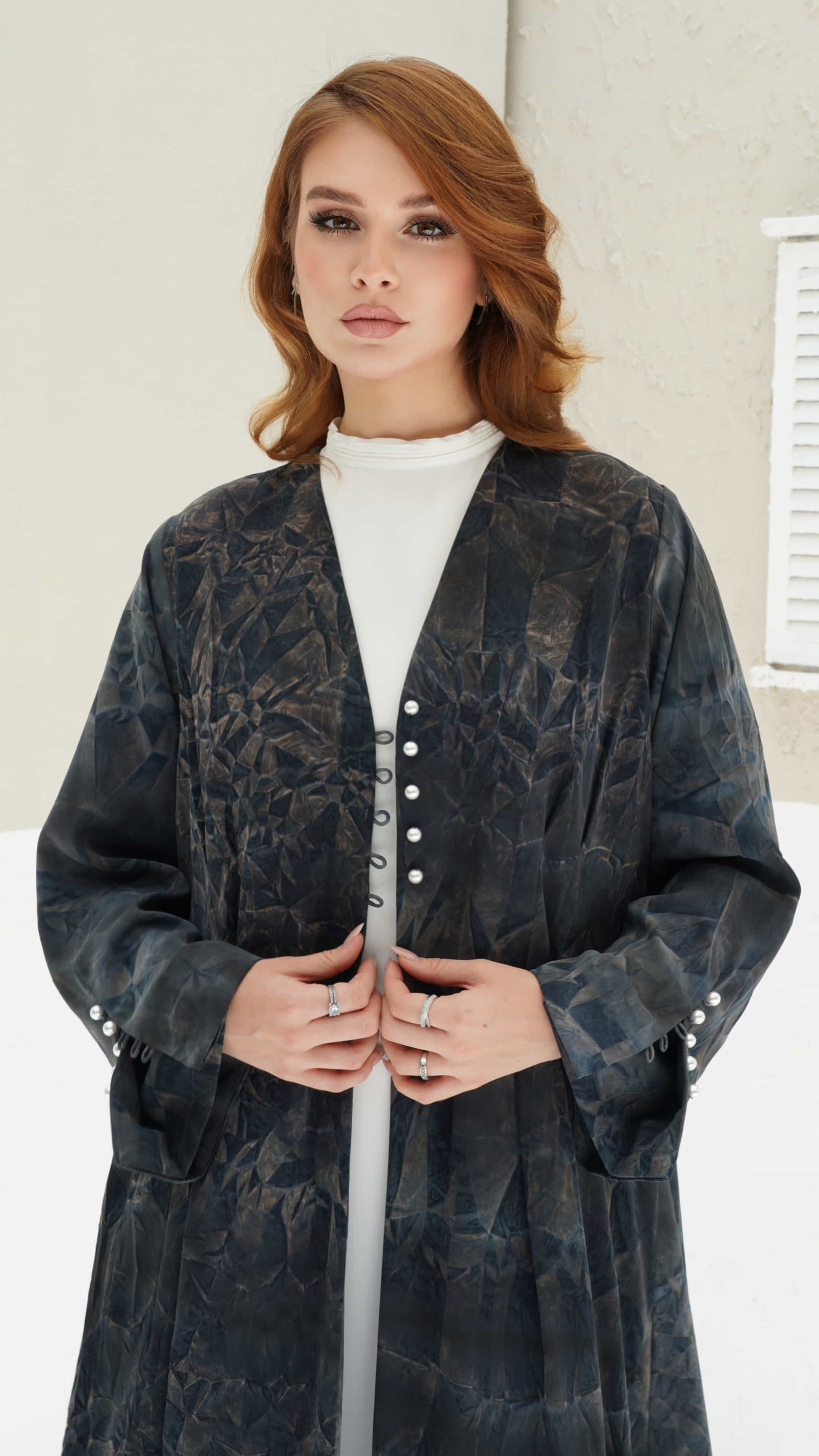 FAIZA | Midnight Mirage Front pose of Faiza abaya highlighting sleeve pearl buttons and soft flowing structure