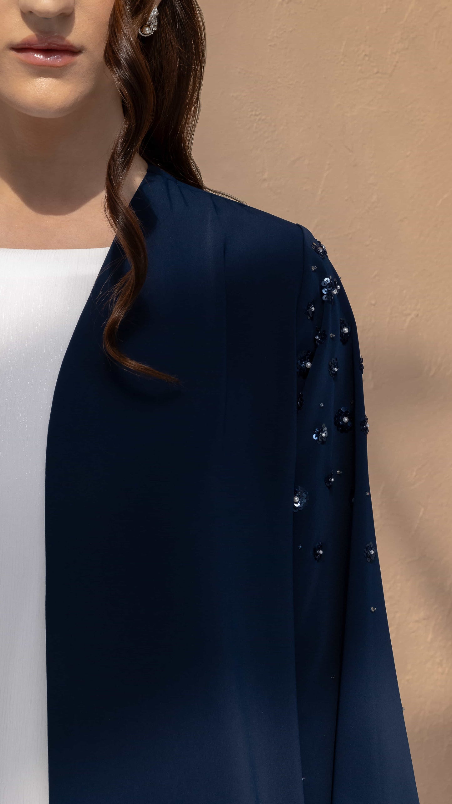 HANA | Sapphire Petal Bloom Close-up sleeve detail with pearl embellishments on navy abaya