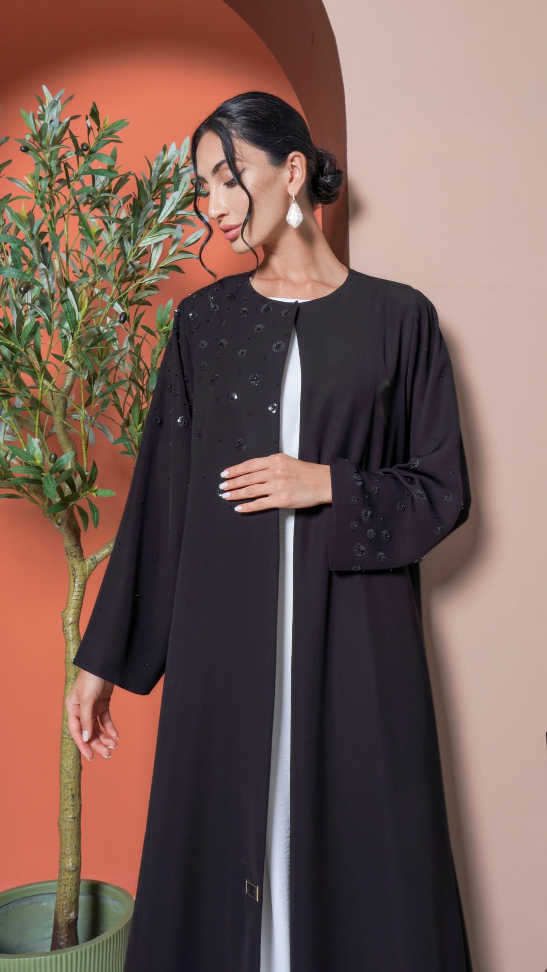 Hana Noir Petal Bloom Elegant black abaya flowing silhouette studio setting