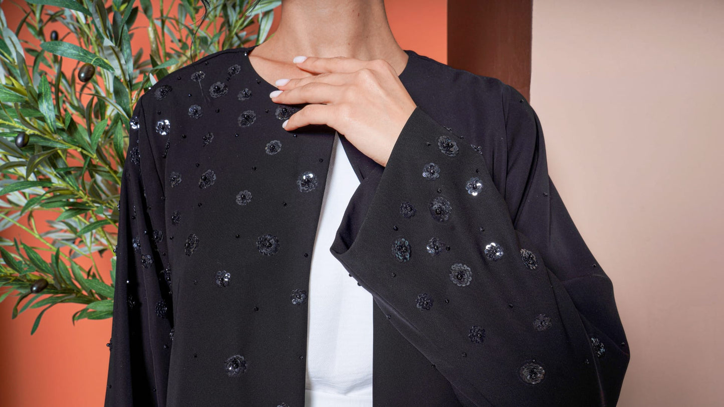 Hana Noir Petal Bloom Minimal black abaya with subtle embellishments front pose