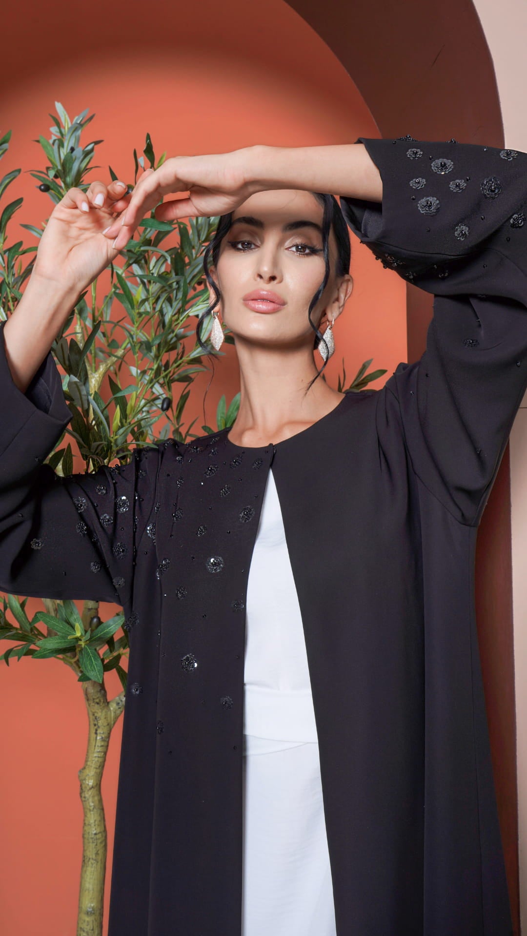 Hana Noir Petal Bloom Black abaya with delicate pearl floral detailing on shoulder close-up