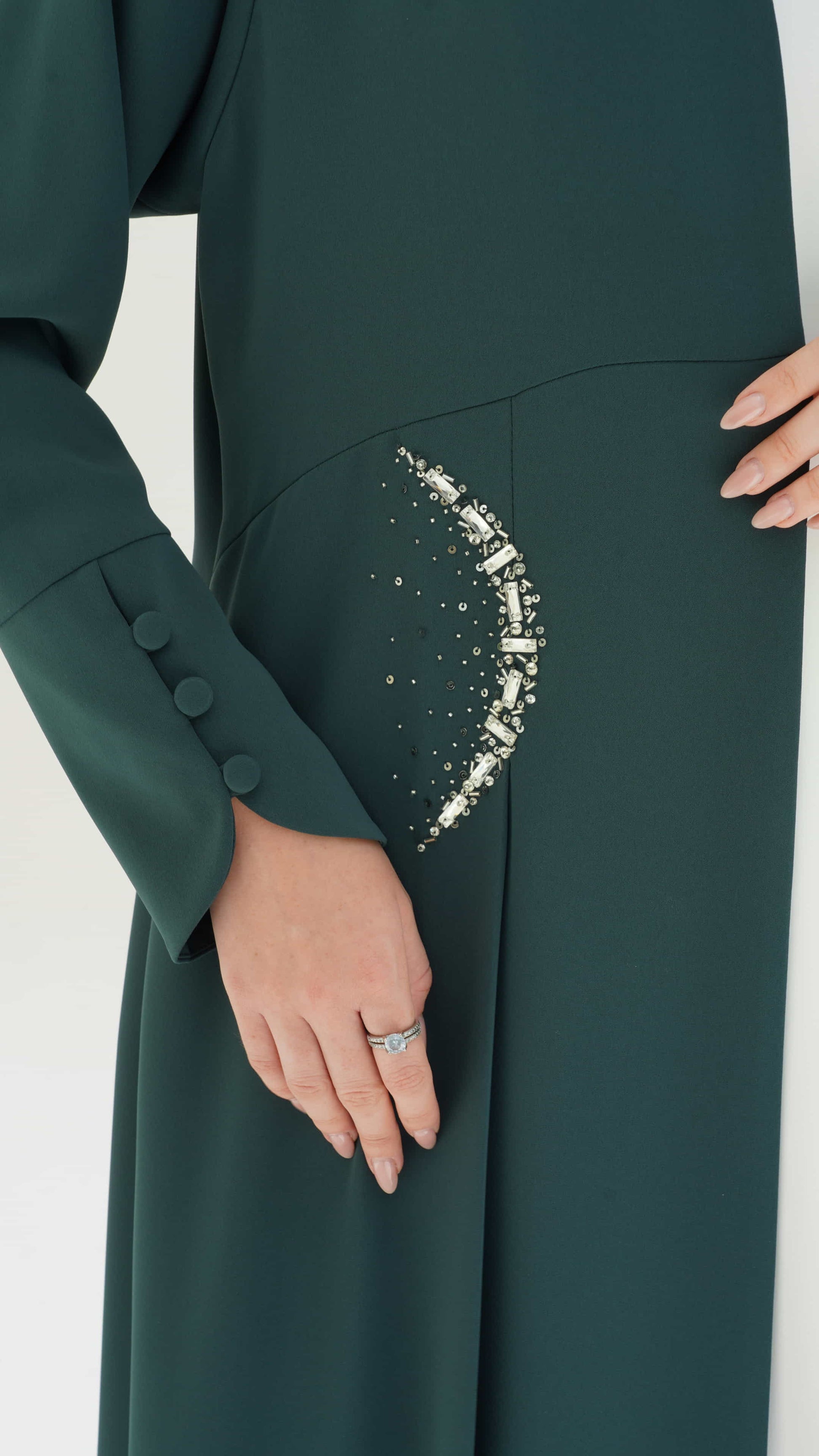 KAINA Emerald Éclat an emerald abaya crescent crystal pocket detail close up