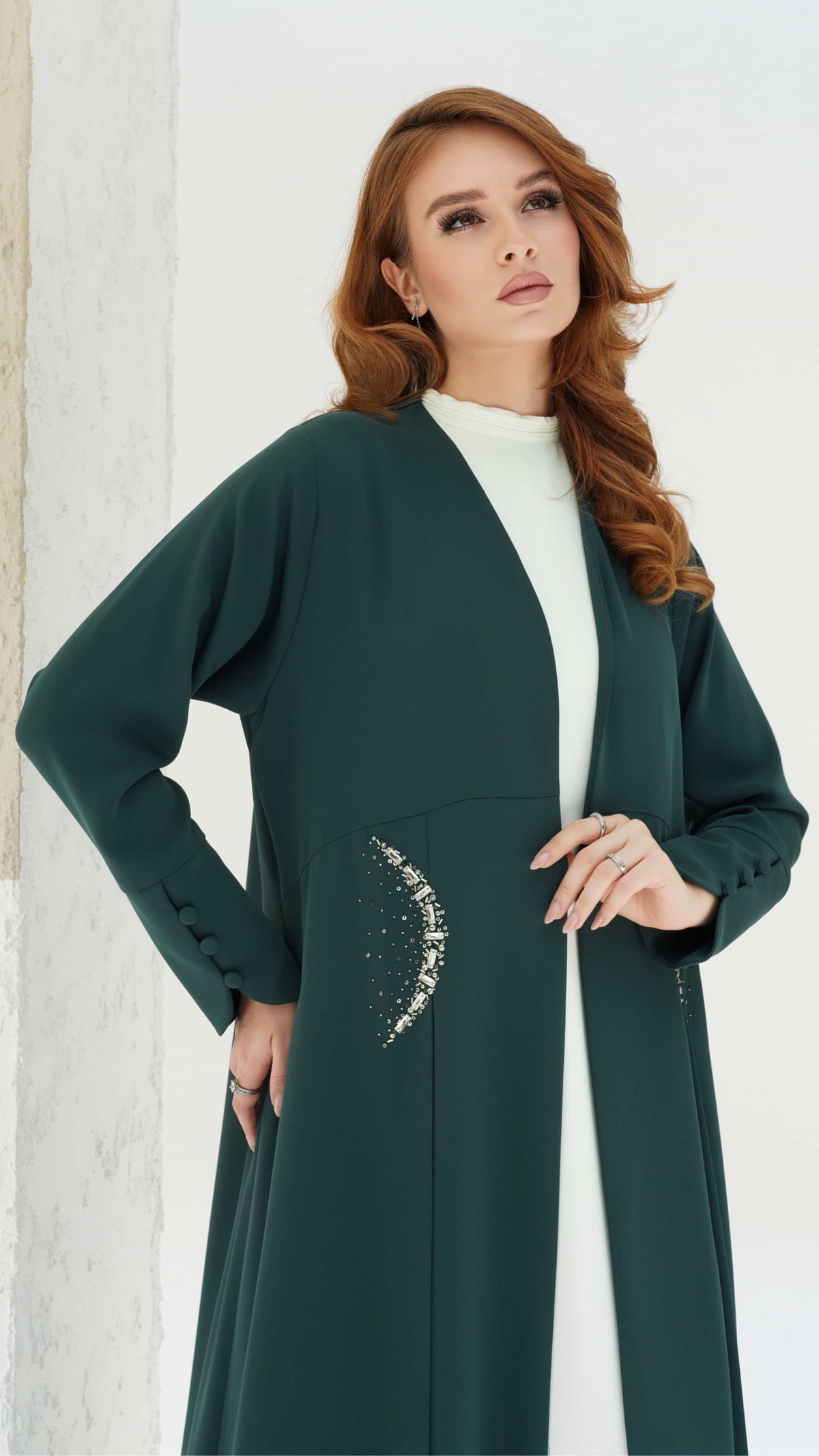 KAINA Emerald Éclat an emerald abaya crescent crystal pocket detail side view