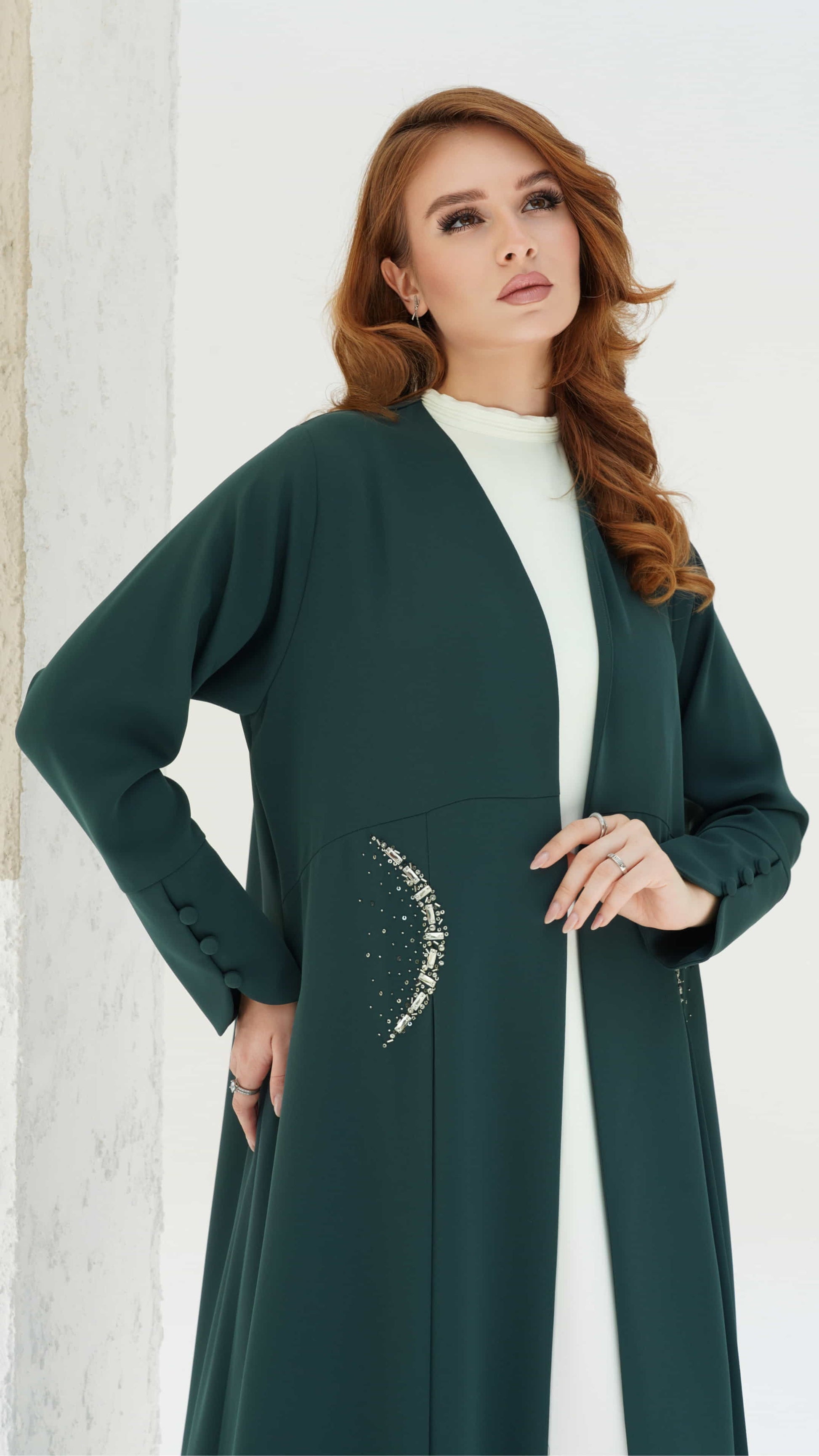 KAINA Emerald Éclat an emerald abaya crescent crystal pocket detail side view