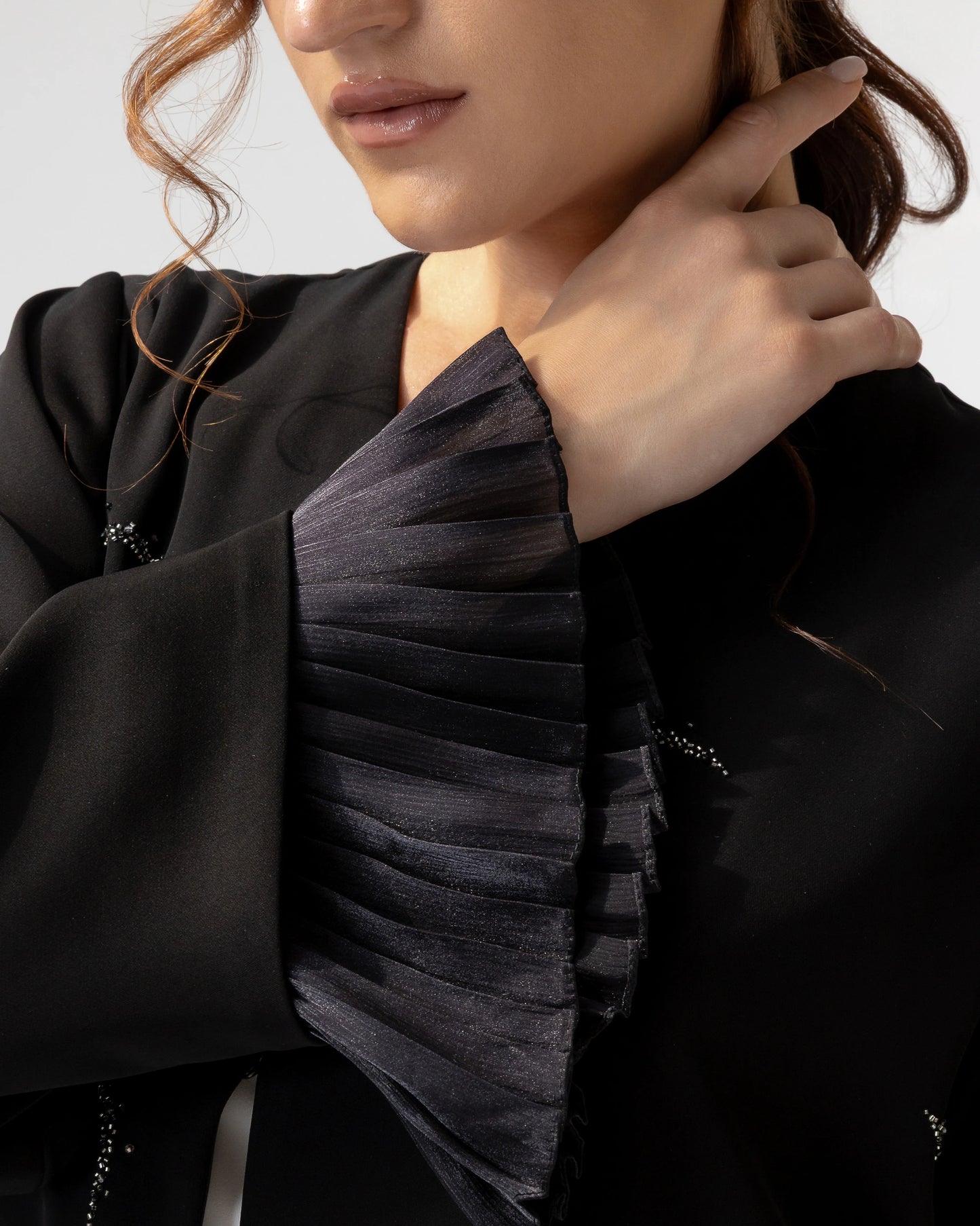 LUNARA Noir Crescent designer abaya showcasing pleated chiffon cuff detailing and refined festive elegance