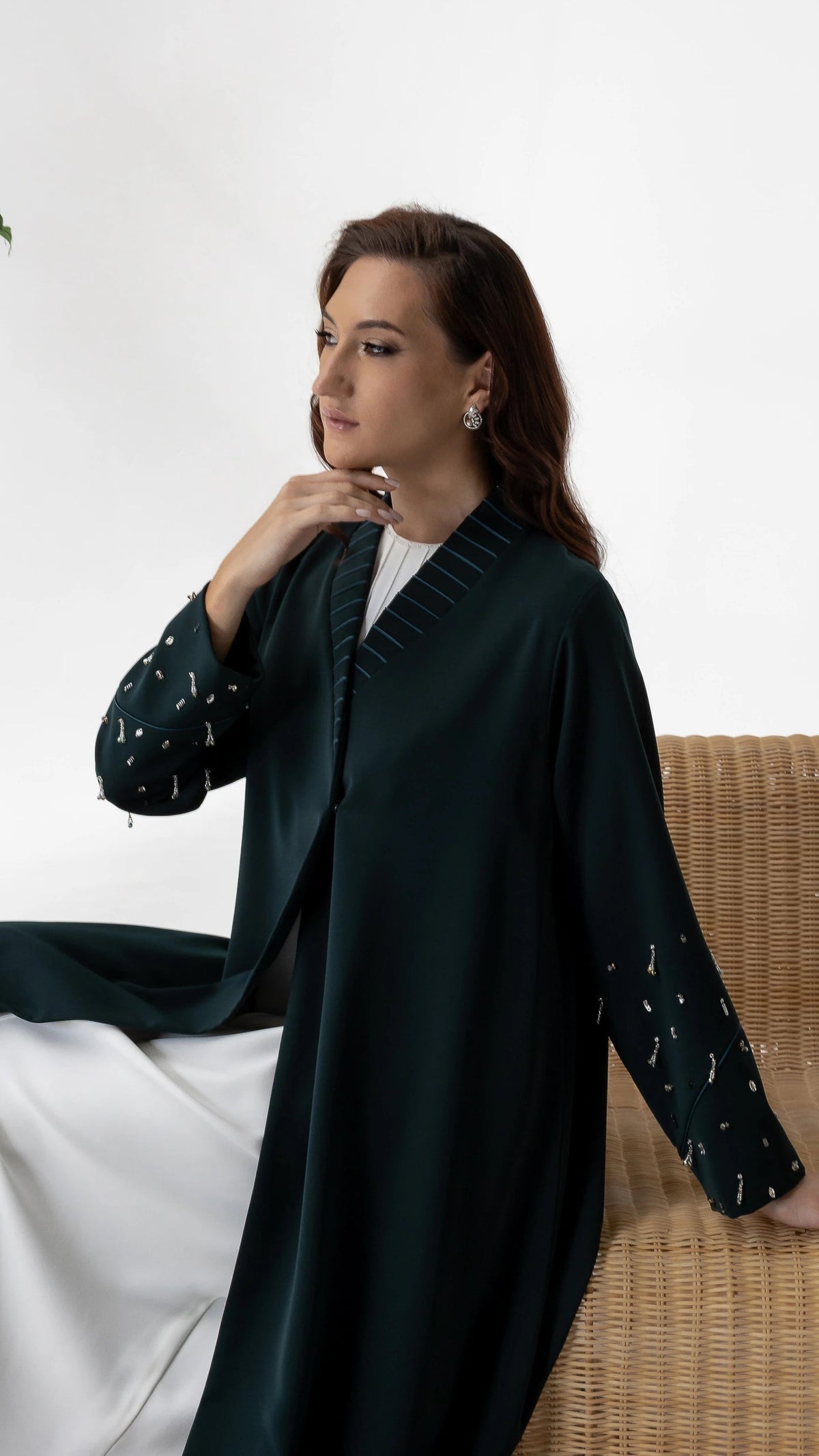 LYRA | Emerald Crystal Luxe Abaya Elegant seated editorial image of emerald crystal embellished abaya