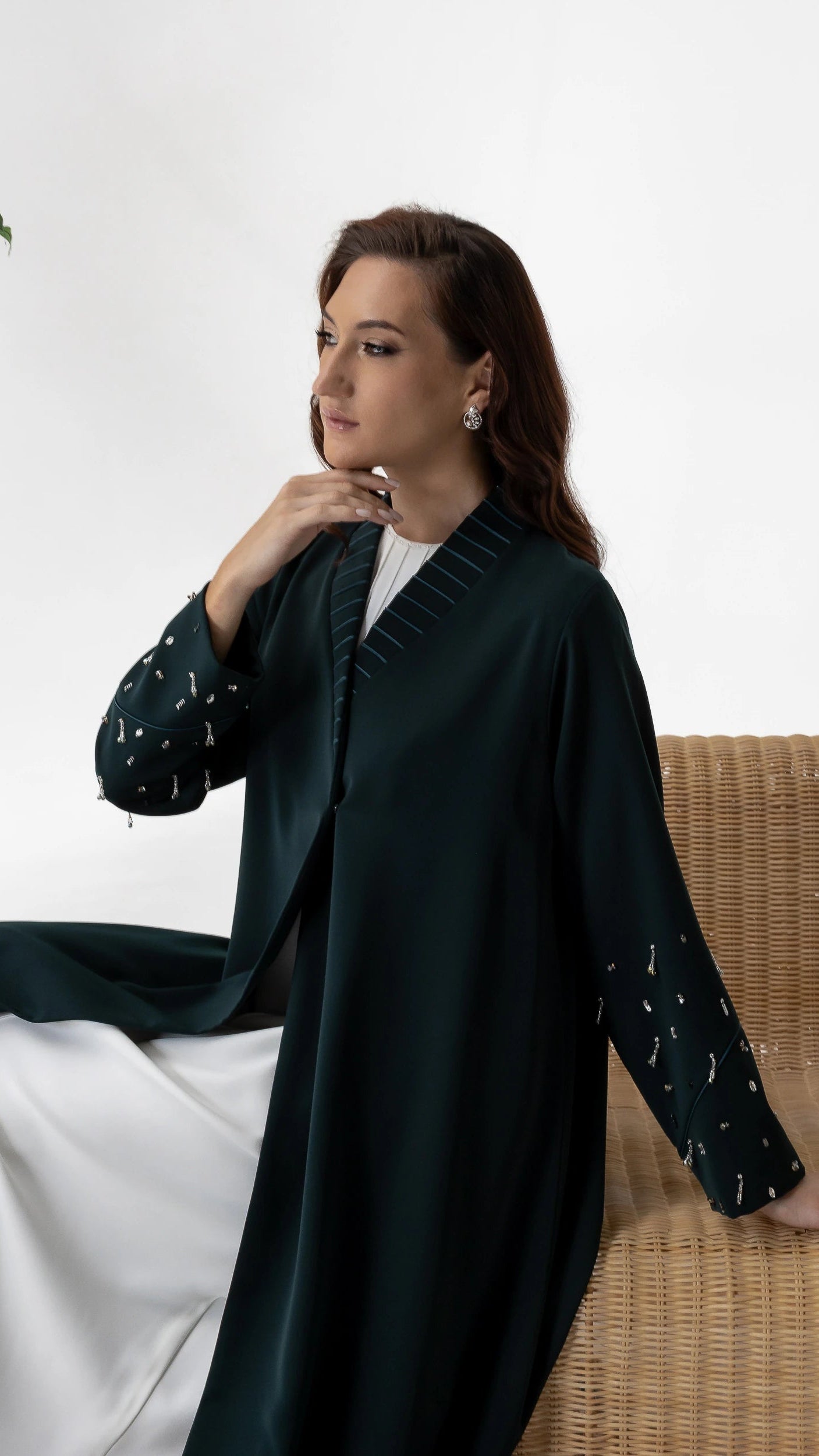 LYRA | Emerald Crystal Luxe Abaya Elegant seated editorial image of emerald crystal embellished abaya