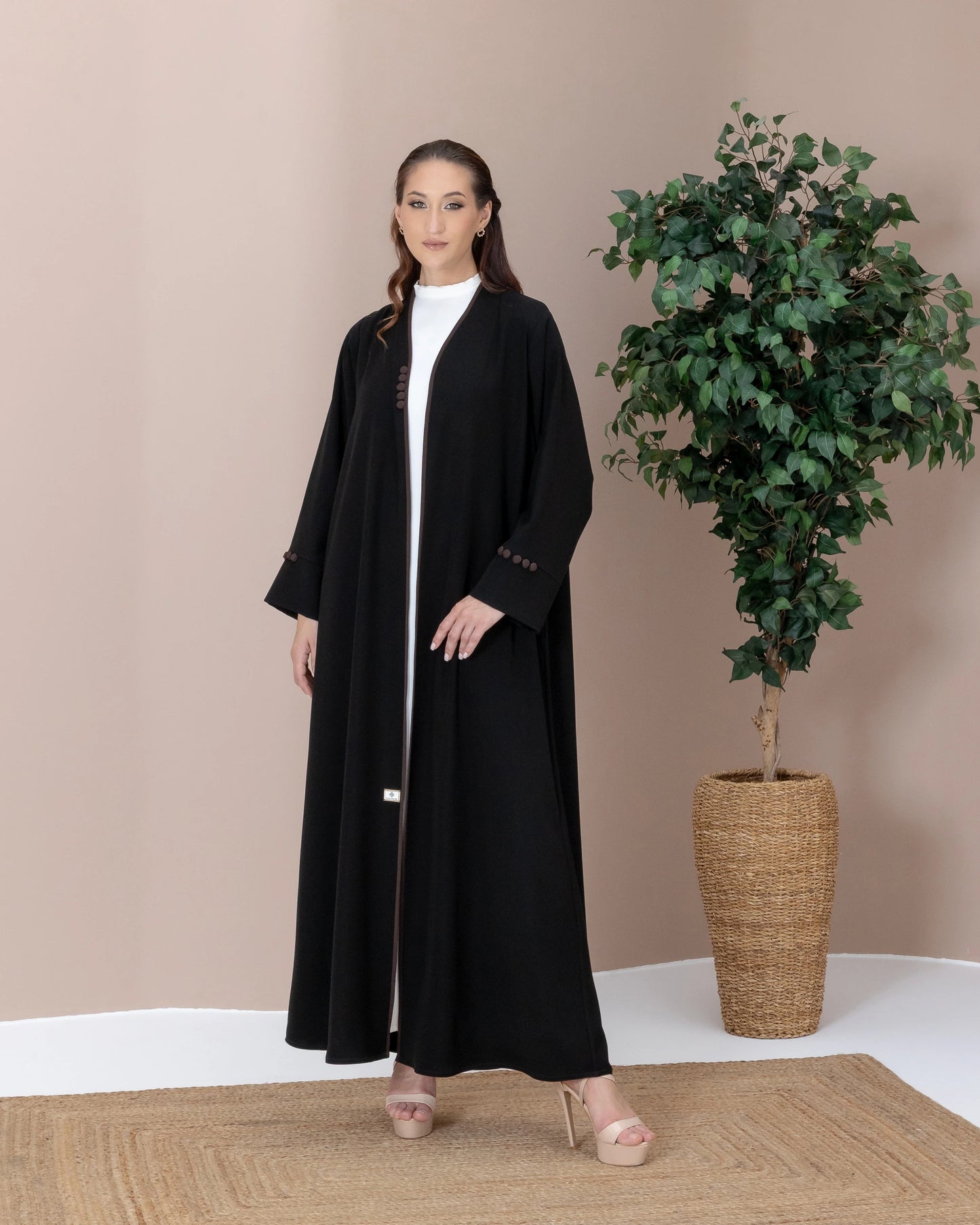 Leen Mocha Trim Abaya neckline with piping detail on a  black silhoutte