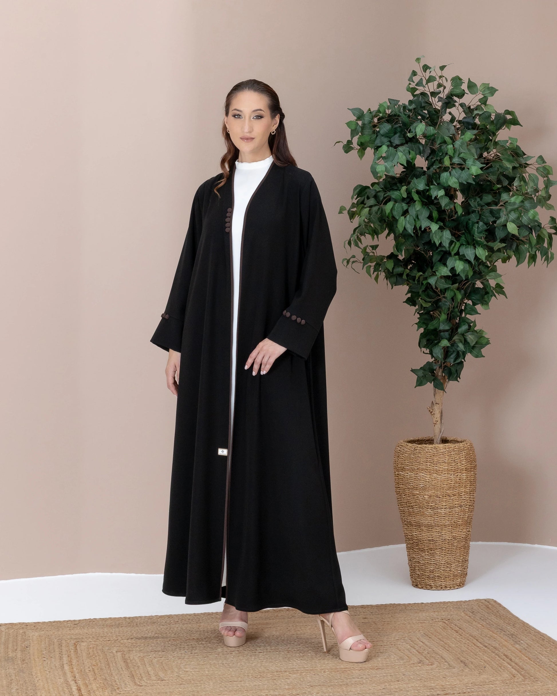 Leen Mocha Trim Abaya neckline with piping detail on a  black silhoutte