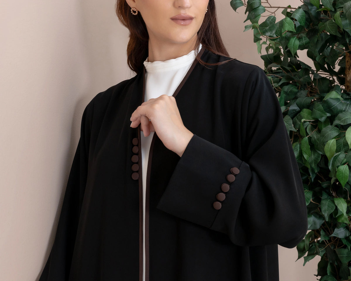 Leen Noir Mocha Trim abaya sleeve detail with fabric covered buttons