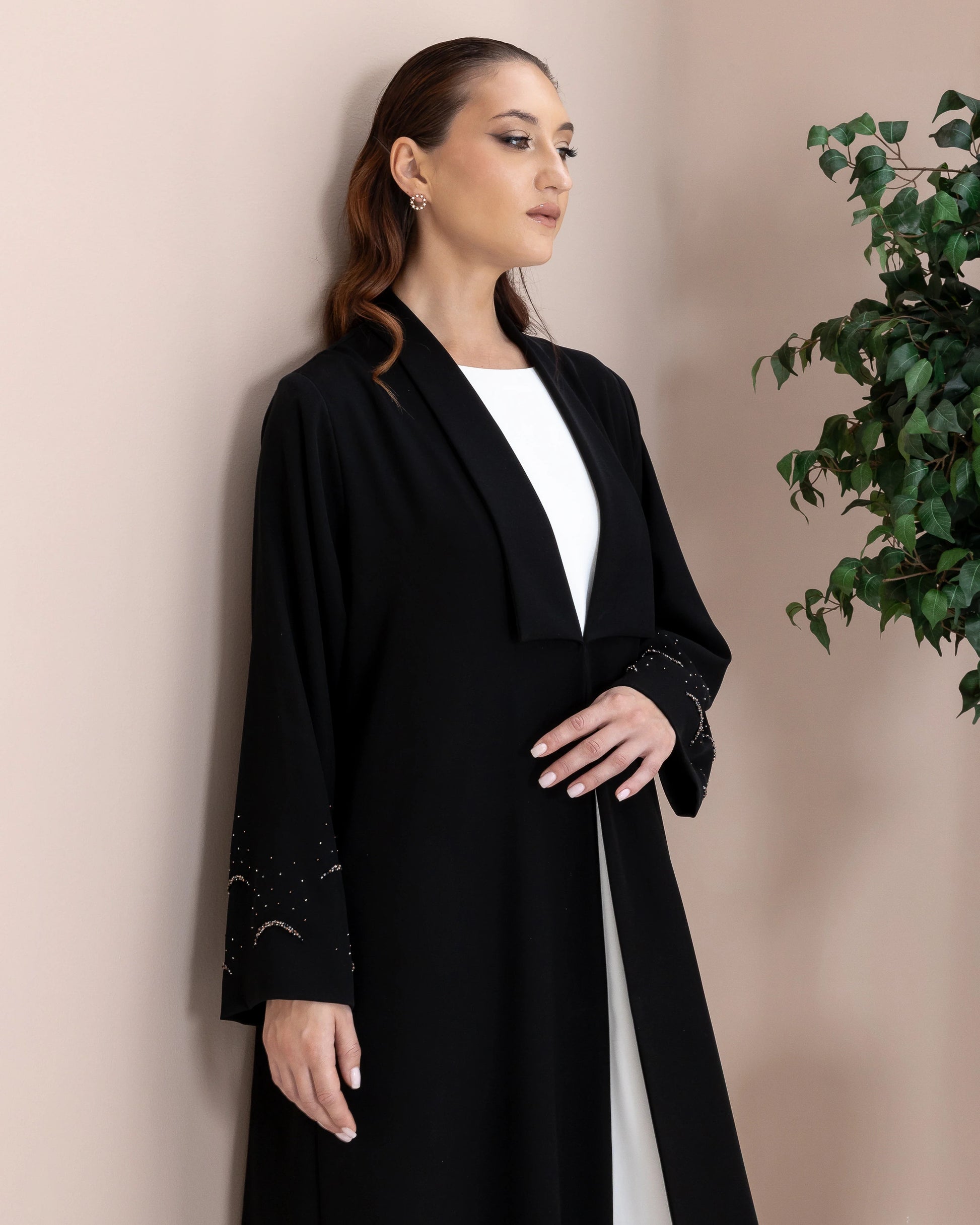 MAHNUR Noir Halo side portrait showcasing elegant collar drape and celestial crystal sleeve artistry