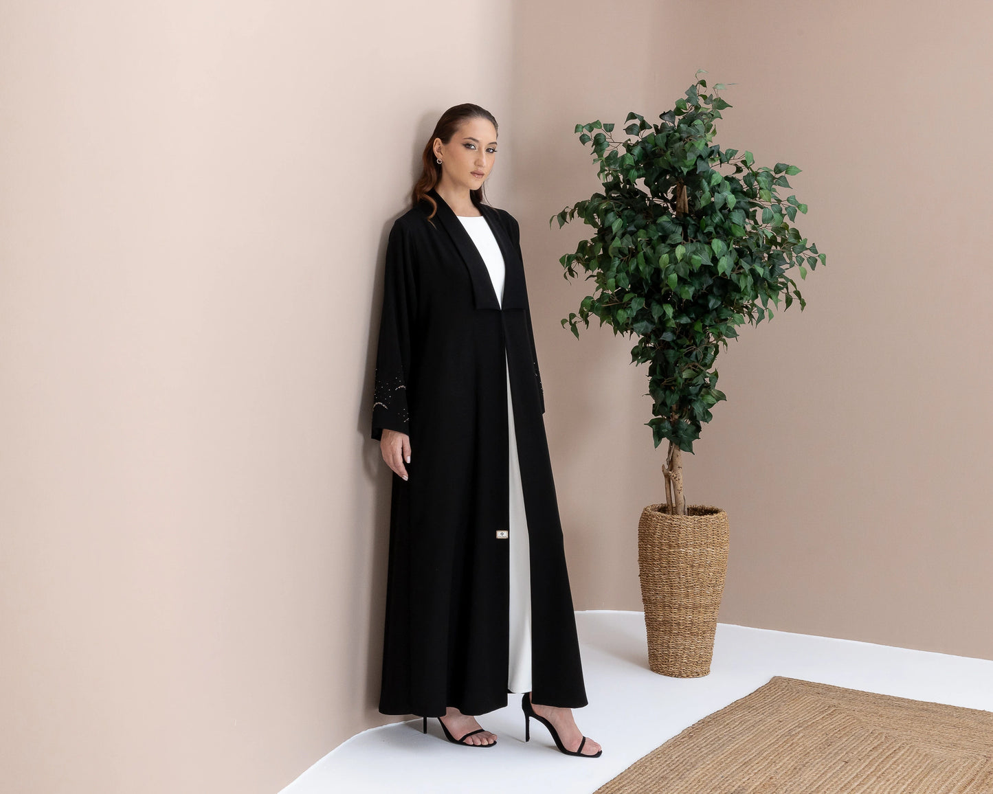 MAHNUR Noir Halo full-length black abaya with fluid silhouette and luminous crystal cuff detailing