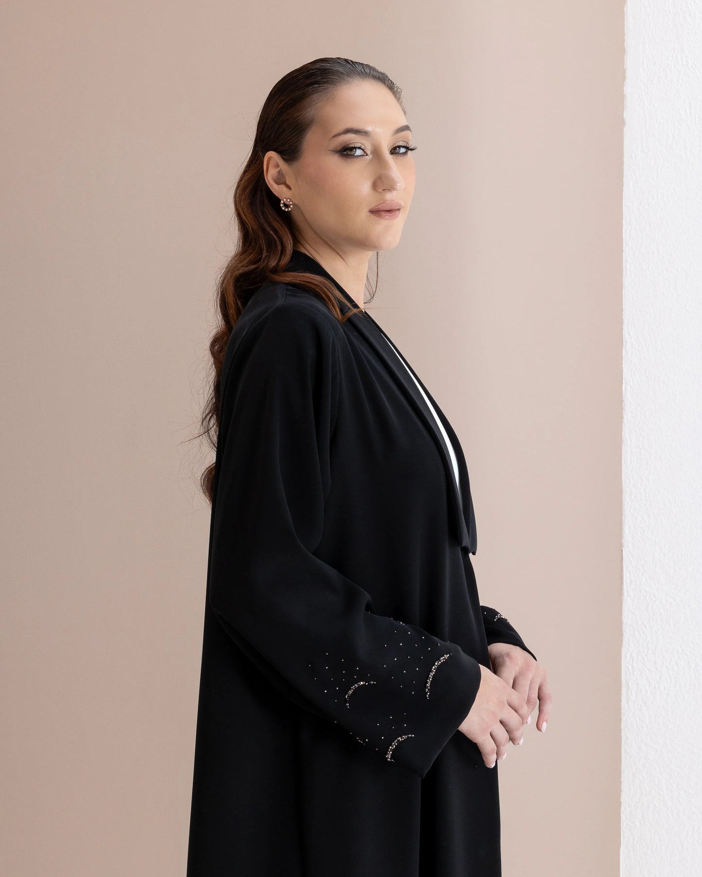 MAHNUR Noir Halo side portrait showcasing elegant collar drape and celestial crystal sleeve artistry