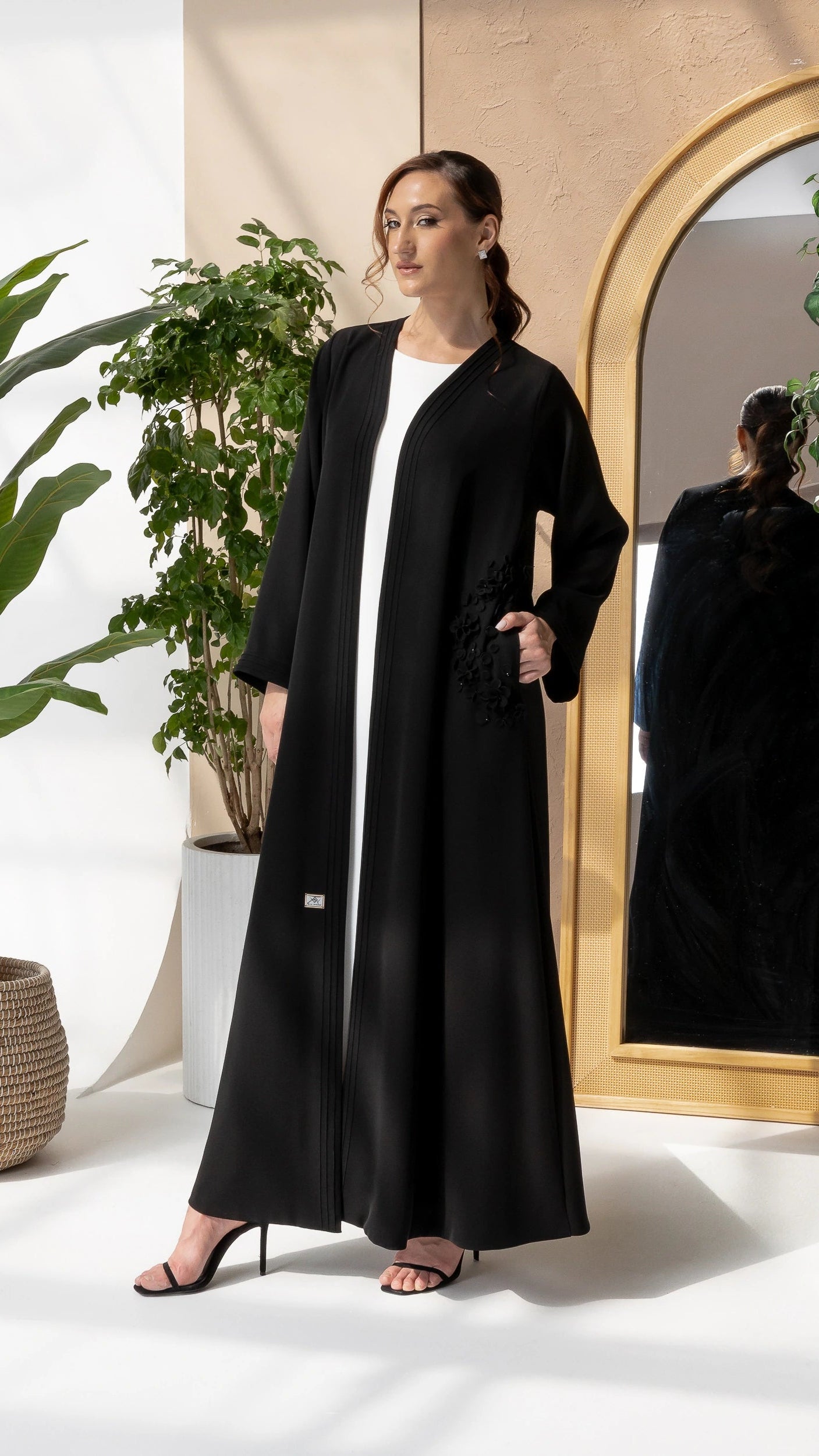 MELINA Noir Blossom luxury black abaya with elegant matte 3D floral detailing and flowing silhouette