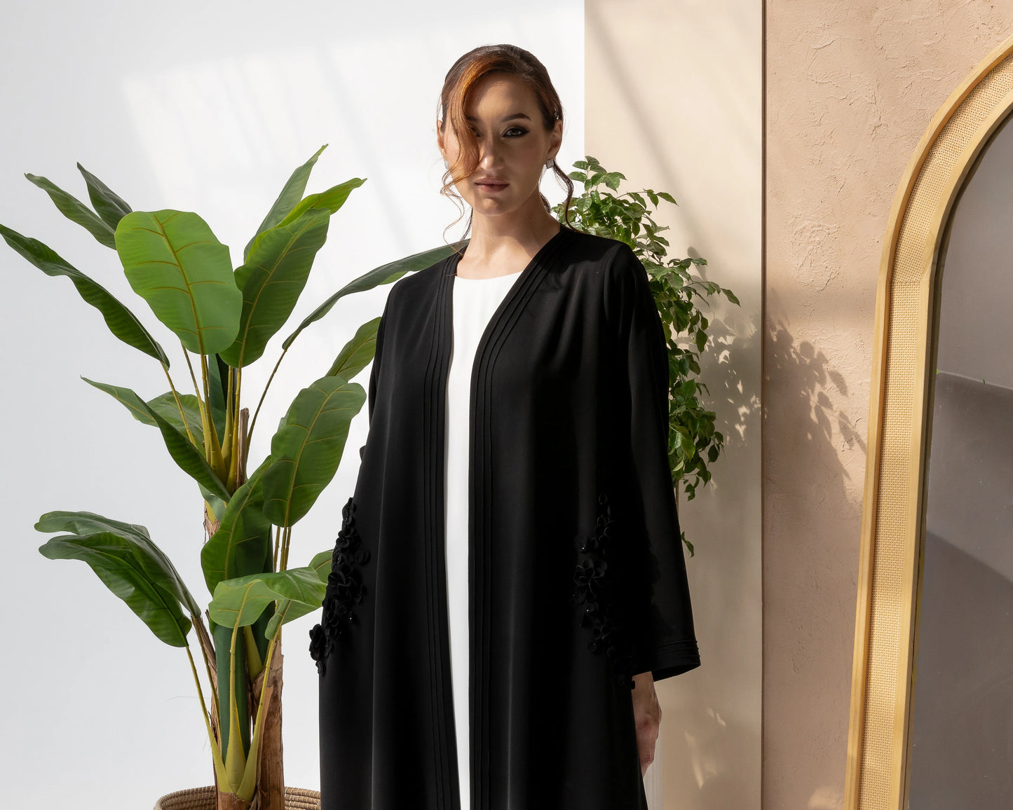 MELINA Noir Blossom close-up of handcrafted black 3D floral embellishments on premium luxury abaya