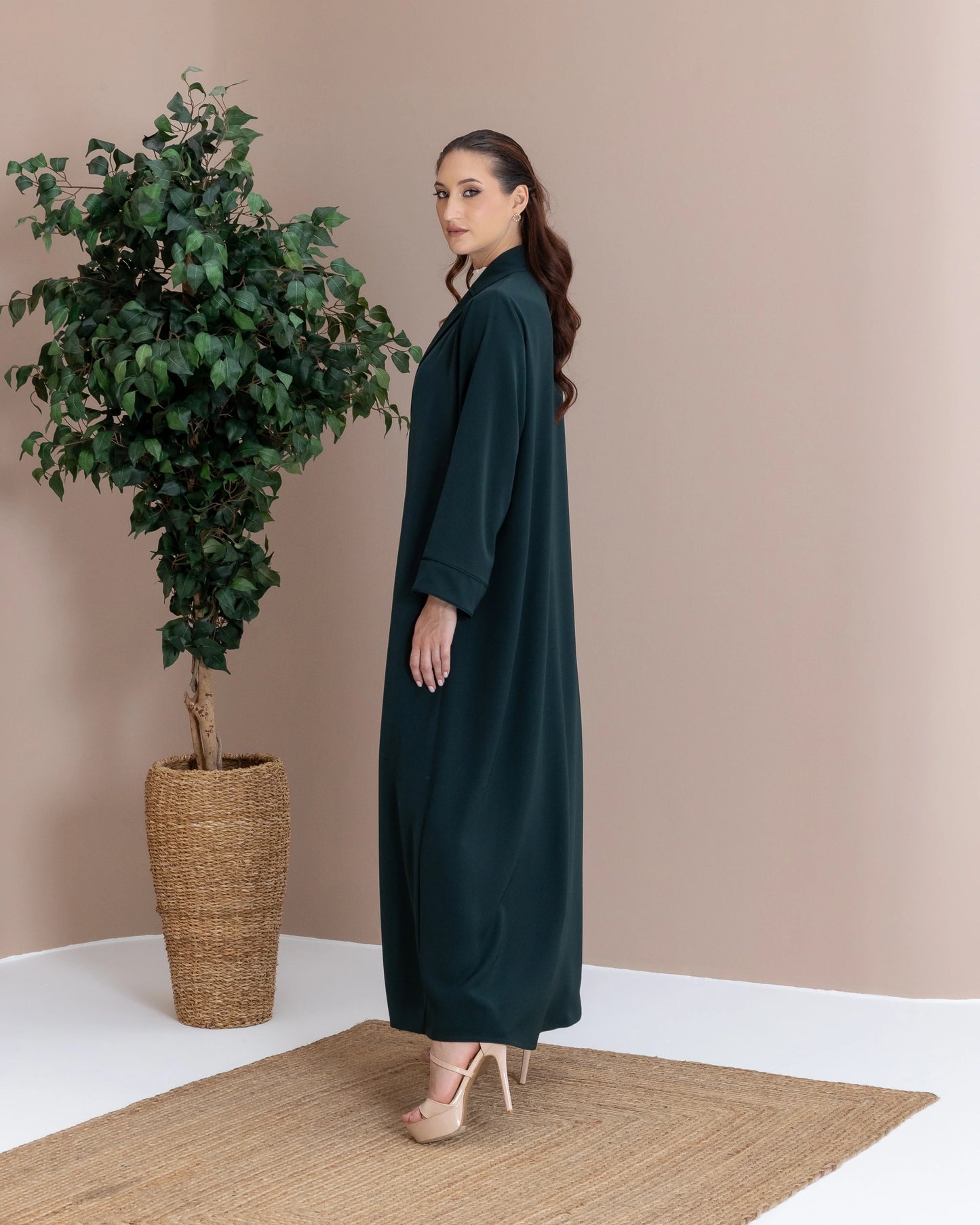 MIRAL Verde Royale modern luxury abaya side pose with fluid silhouette and minimalist elegance