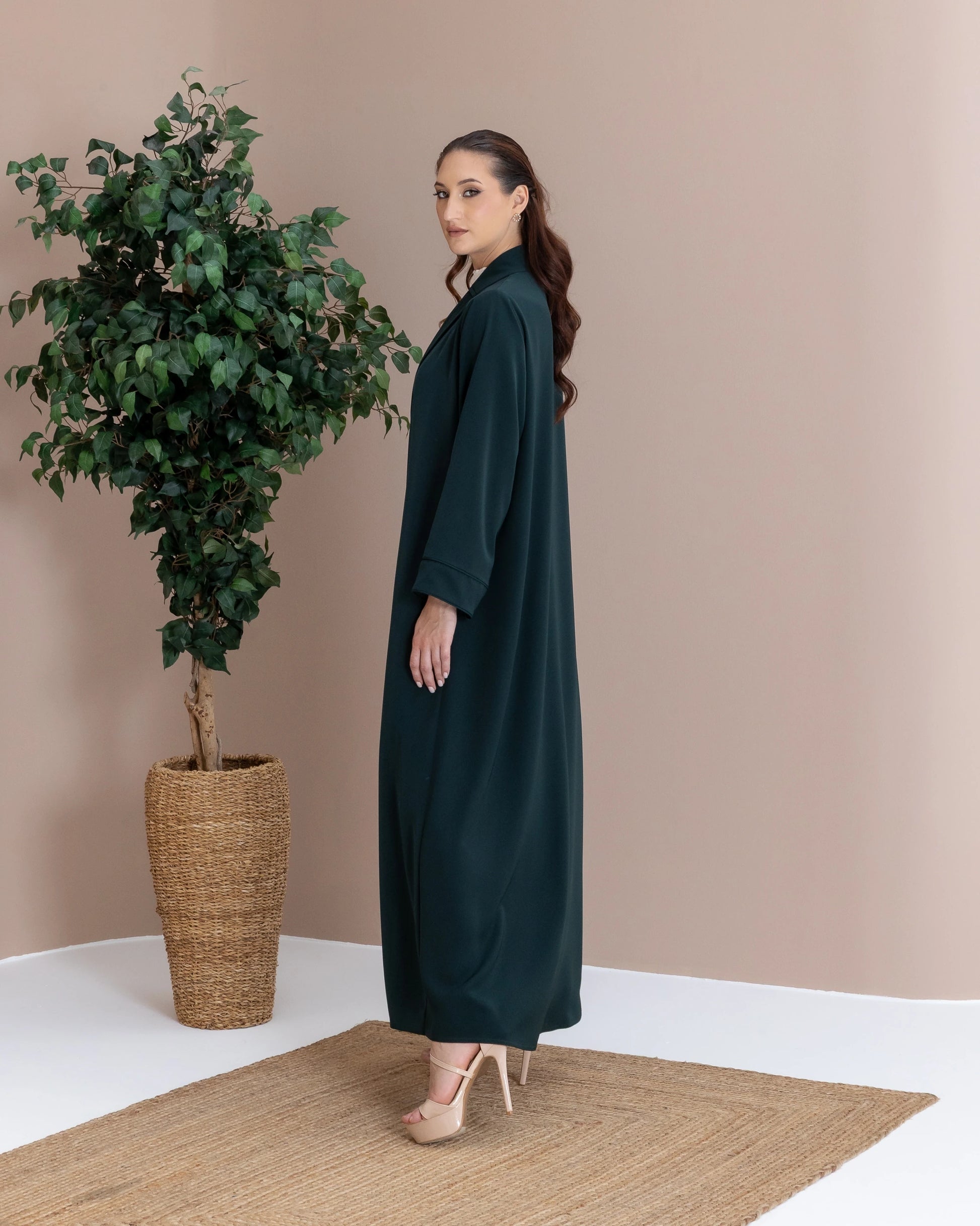 MIRAL Verde Royale modern luxury abaya side pose with fluid silhouette and minimalist elegance