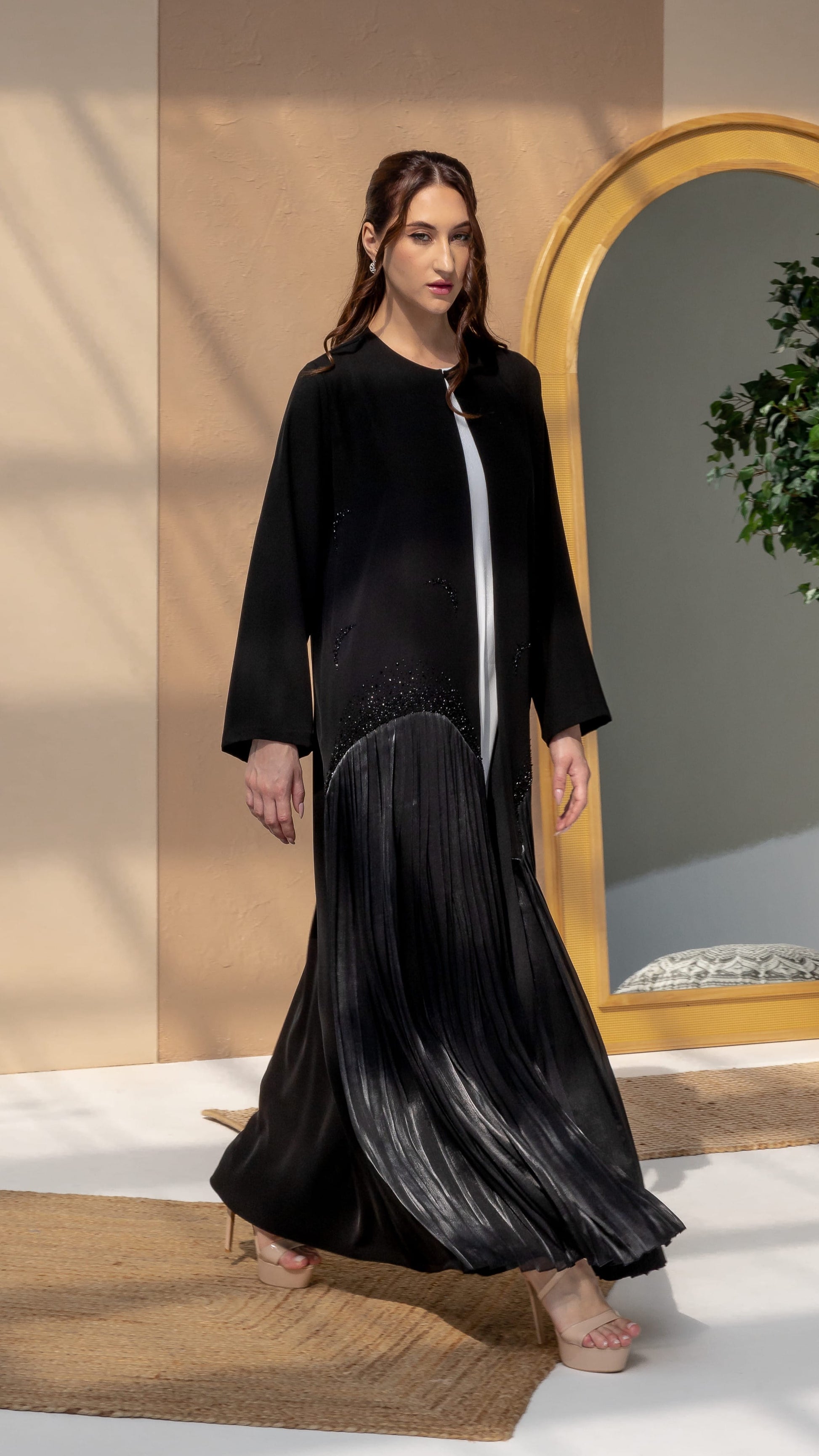 MIRA | Noir Shadow Luxe Elegant movement shot of Mira Noir Shadow Luxe flowing abaya silhouette