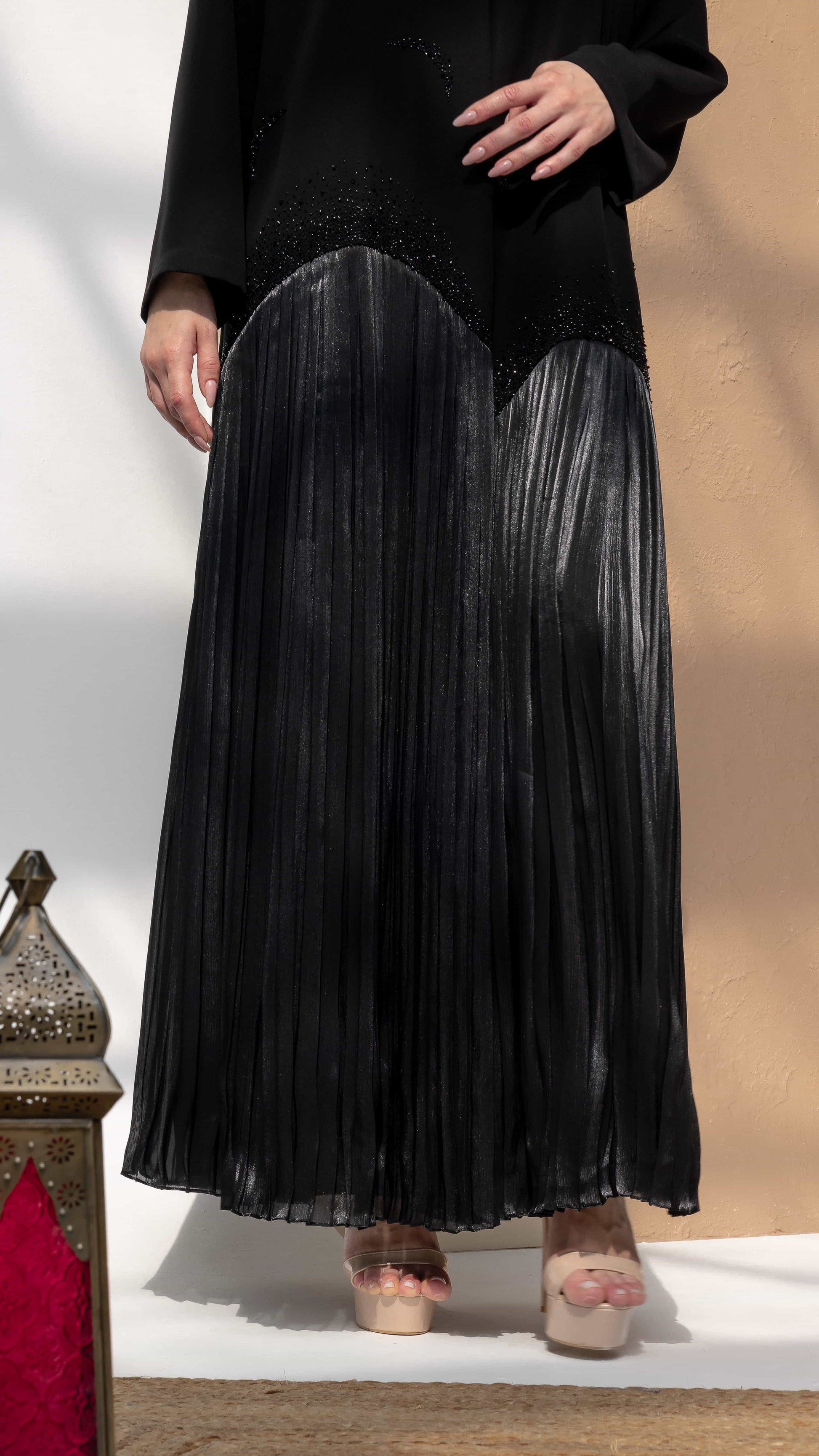 MIRA | Noir Shadow Luxe Black luxury abaya Mira Noir Shadow Luxe showing pleated lower panel movement