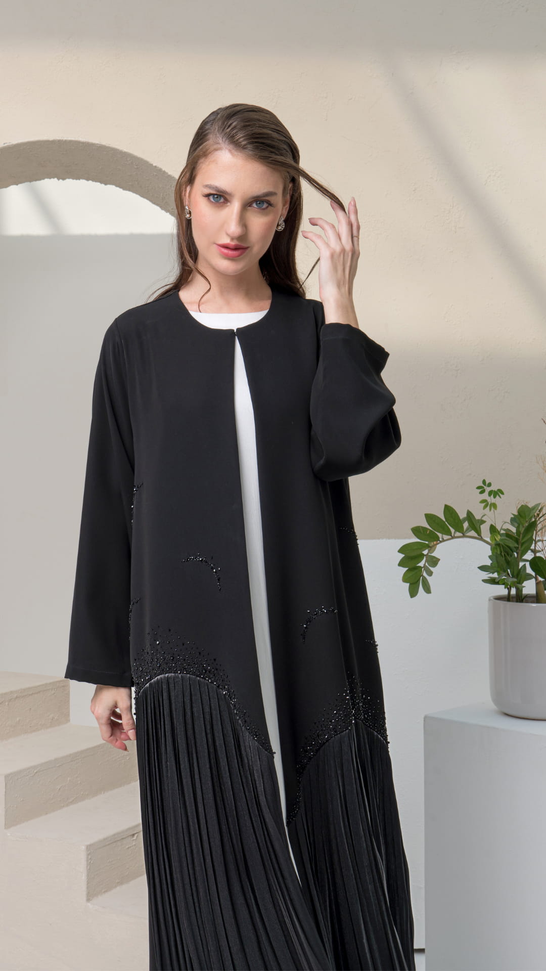MIRA | Shadow Luxe Elegant movement shot of Mira Noir Shadow Luxe flowing abaya silhouette