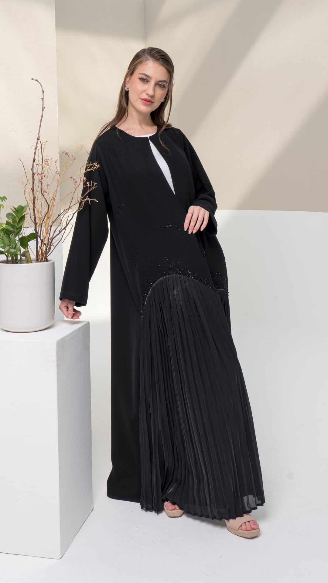 MIRA | Shadow Luxe 2.0 Side angle of Mira Noir Shadow Luxe abaya showing fluid pleated structure