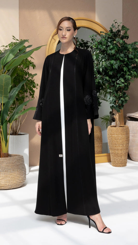 NAFISA | Noir Blossom Luxe, a luxury black abaya with elegant 3D floral sleeve embellishment full-length view