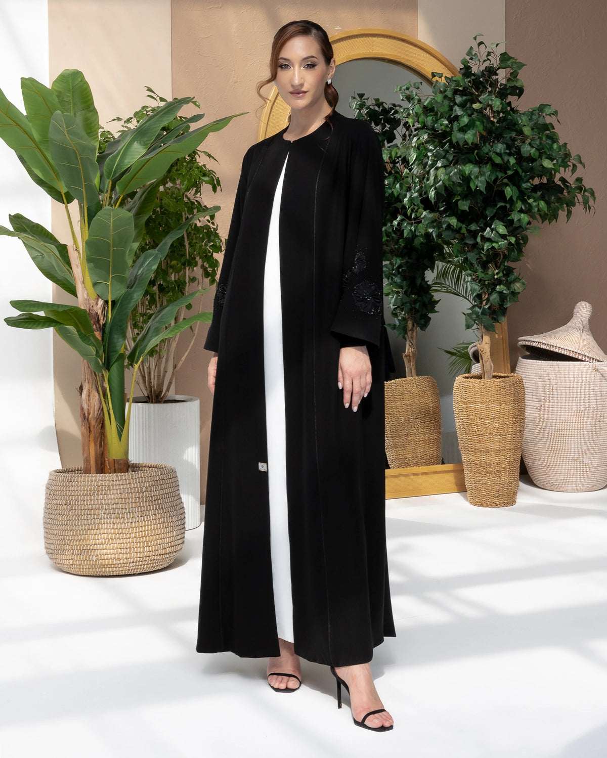 NAFISA | Noir Blossom Luxe Abaya, a luxury black abaya with elegant 3D floral sleeve embellishment full-length view