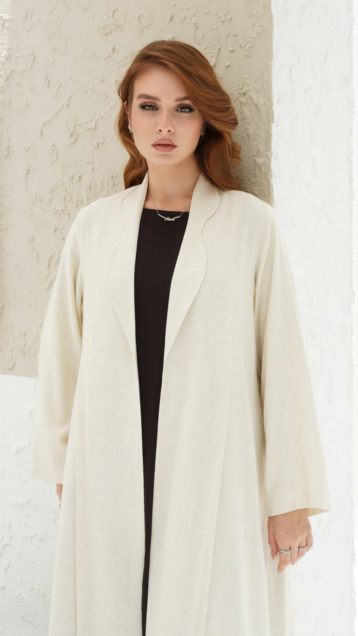 NAIMA | Ivory Elan - Elegant ivory abaya showcasing minimalist tailored design