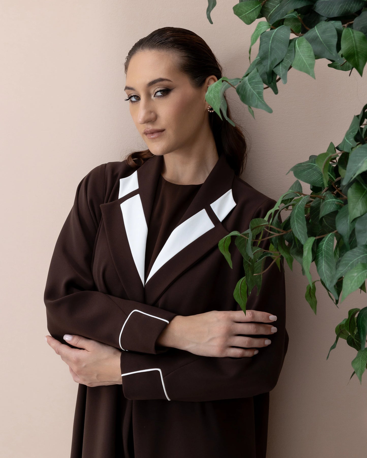 NAZRA Espresso Bianco luxury brown abaya with white contrast lapel detail close-up portrait