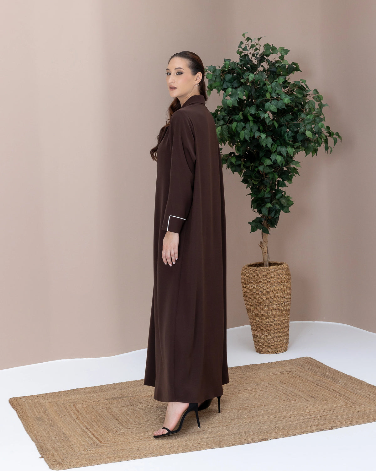 NAZRA Espresso Bianco side-profile luxury abaya showcasing clean minimalist tailoring