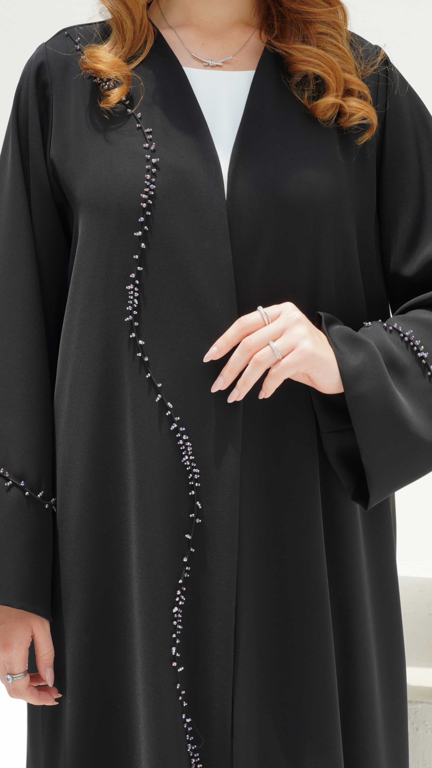 NISREEN | Noir Cascade Close up of hand beaded cascade detail on black abaya