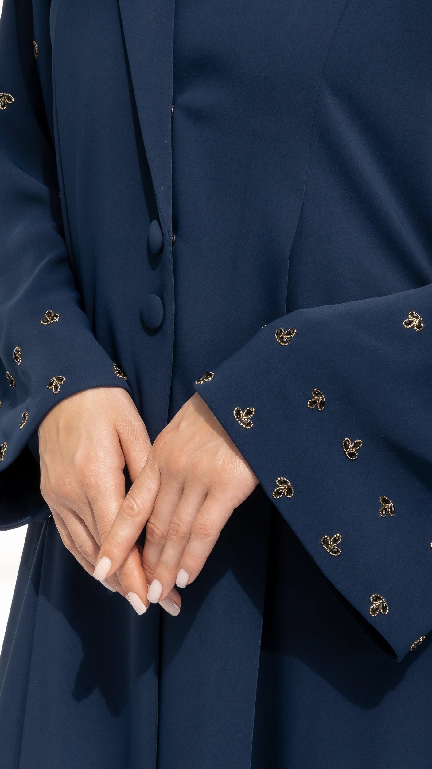 NUJUMA Midnight Luxe close-up of gold constellation embellishments on midnight navy sleeves