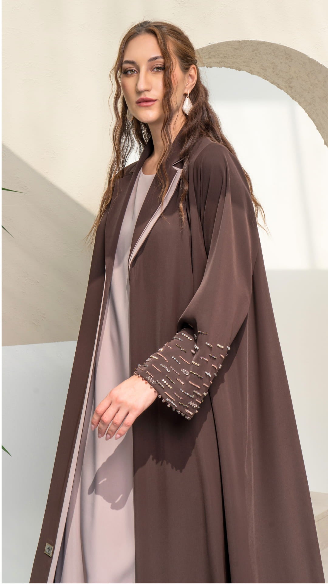 RANYA | Cocoa Crystal Rain Side profile of brown abaya showing soft mauve inner contrast and fluid drape