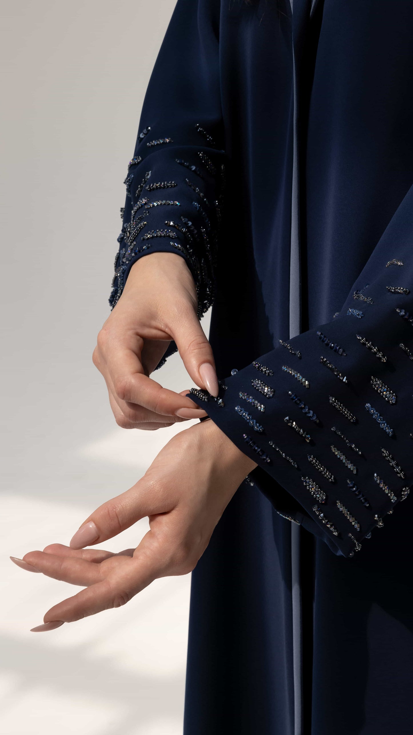 RANYA | Midnight Crystal Rain Close-up of navy abaya sleeve with linear crystal beadwork rain pattern