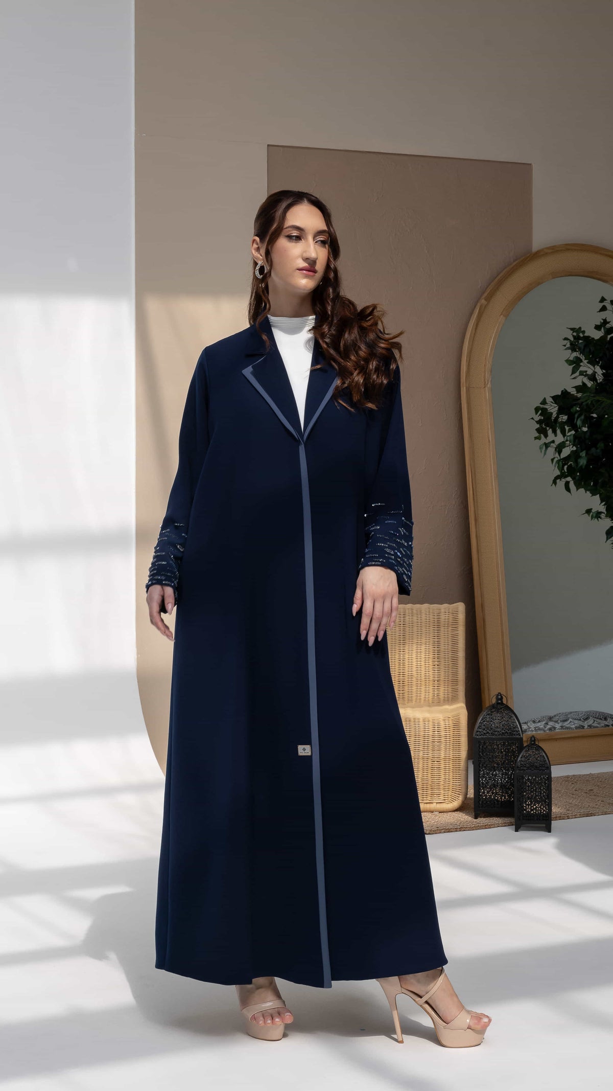 RANYA | Midnight Crystal Rain Editorial Pose Navy luxury abaya with contrast blue lapel collar and linear crystal beadwork sleeves front view