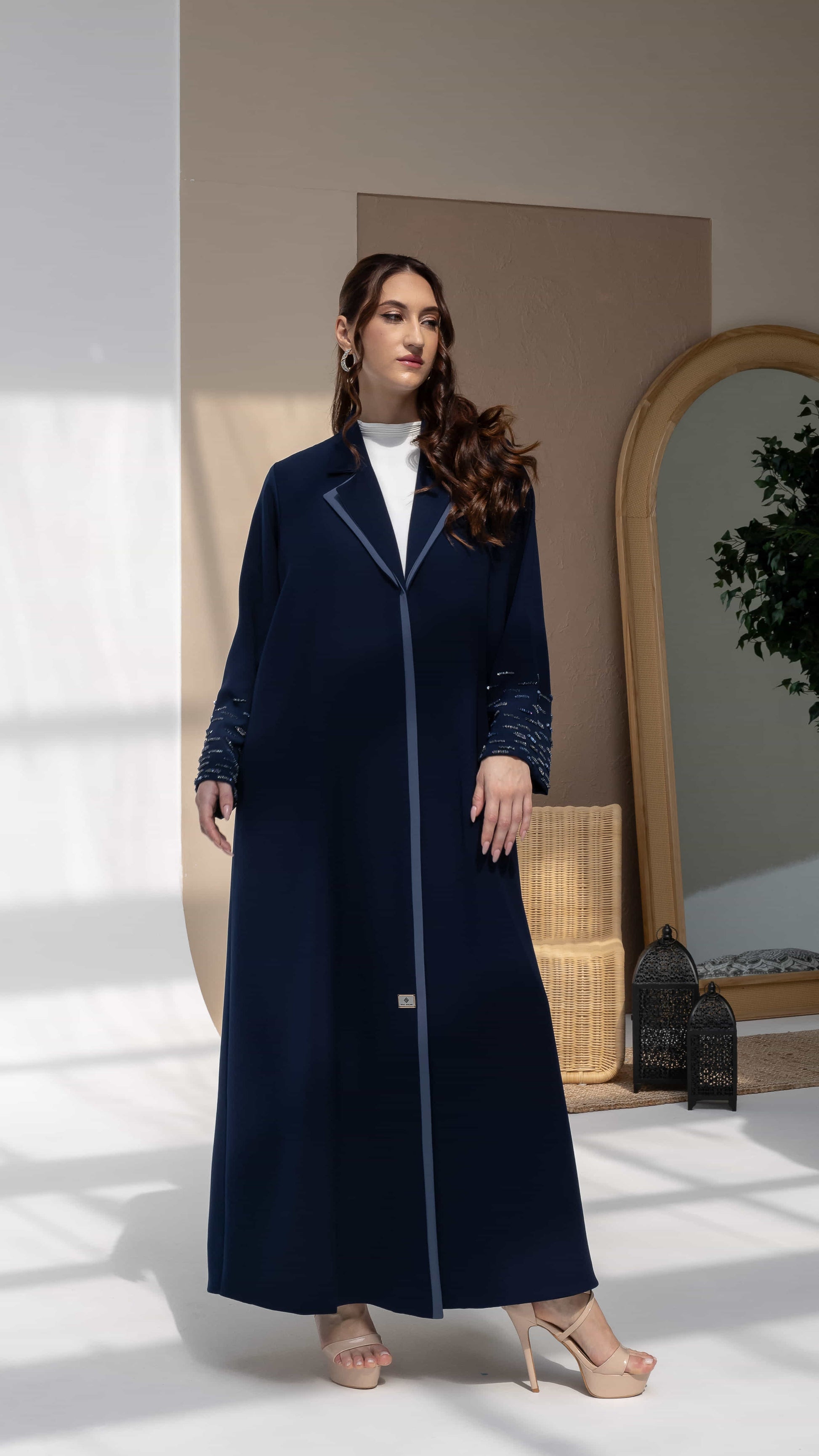 RANYA | Midnight Crystal Rain Editorial Pose Navy luxury abaya with contrast blue lapel collar and linear crystal beadwork sleeves front view