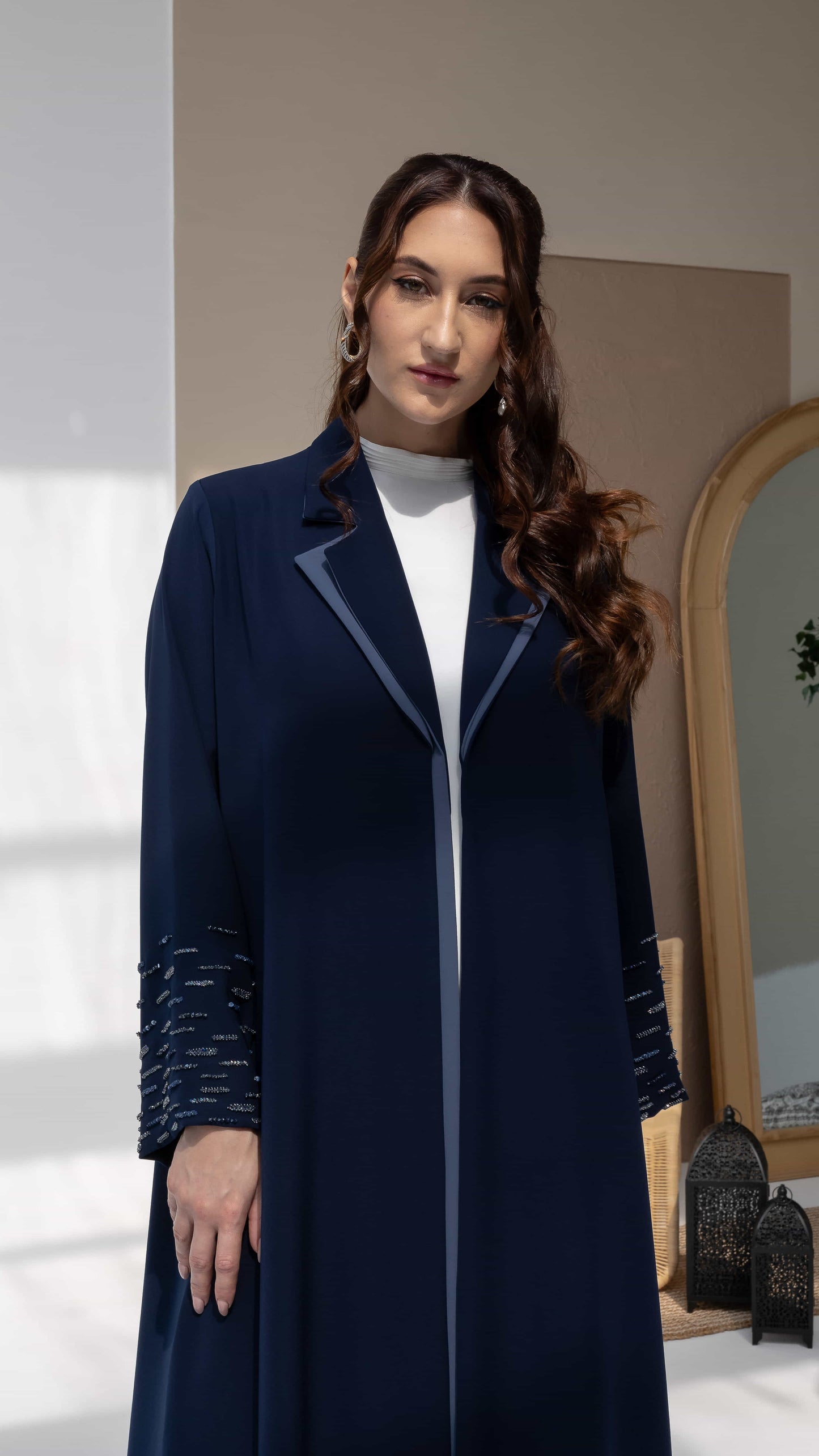 RANYA | Midnight Crystal Rain Model wearing navy abaya with embellished sleeves and minimal luxury styling
