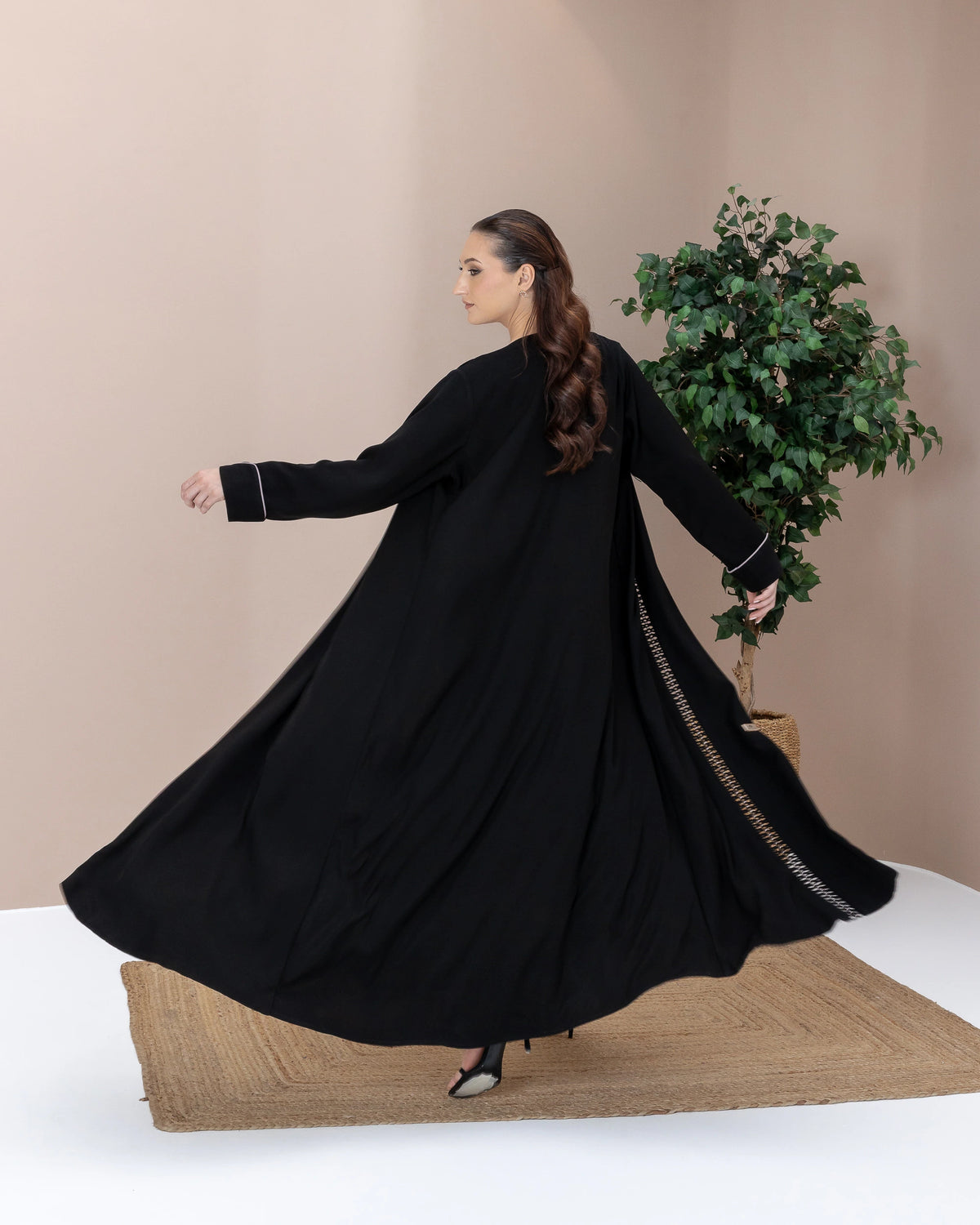 RASMAH Eclipse Noir dramatic flowing black abaya motion shot with elegant silhouette