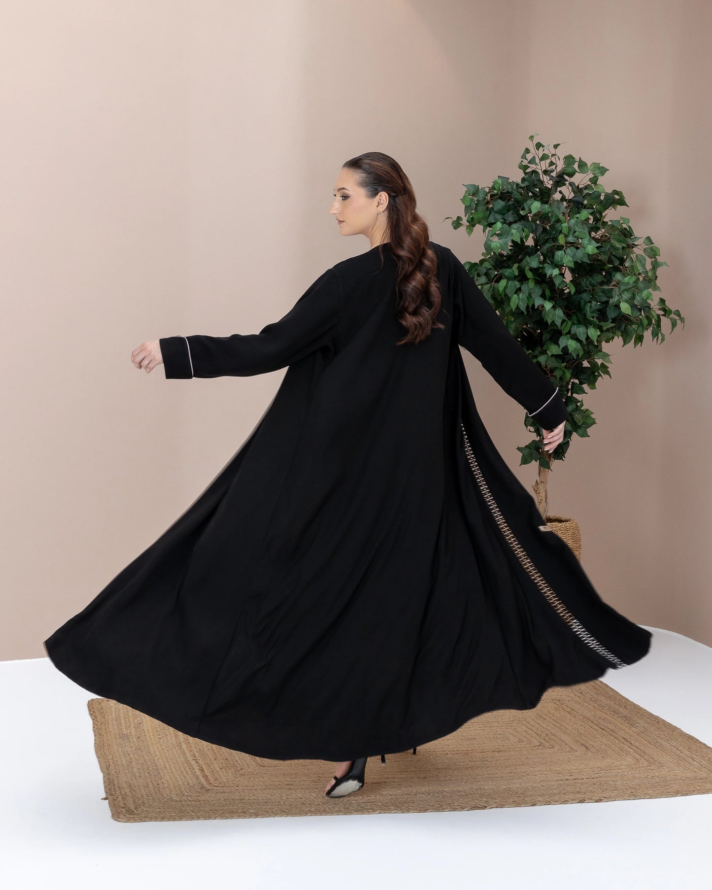RASMAH Eclipse Noir dramatic flowing black abaya motion shot with elegant silhouette