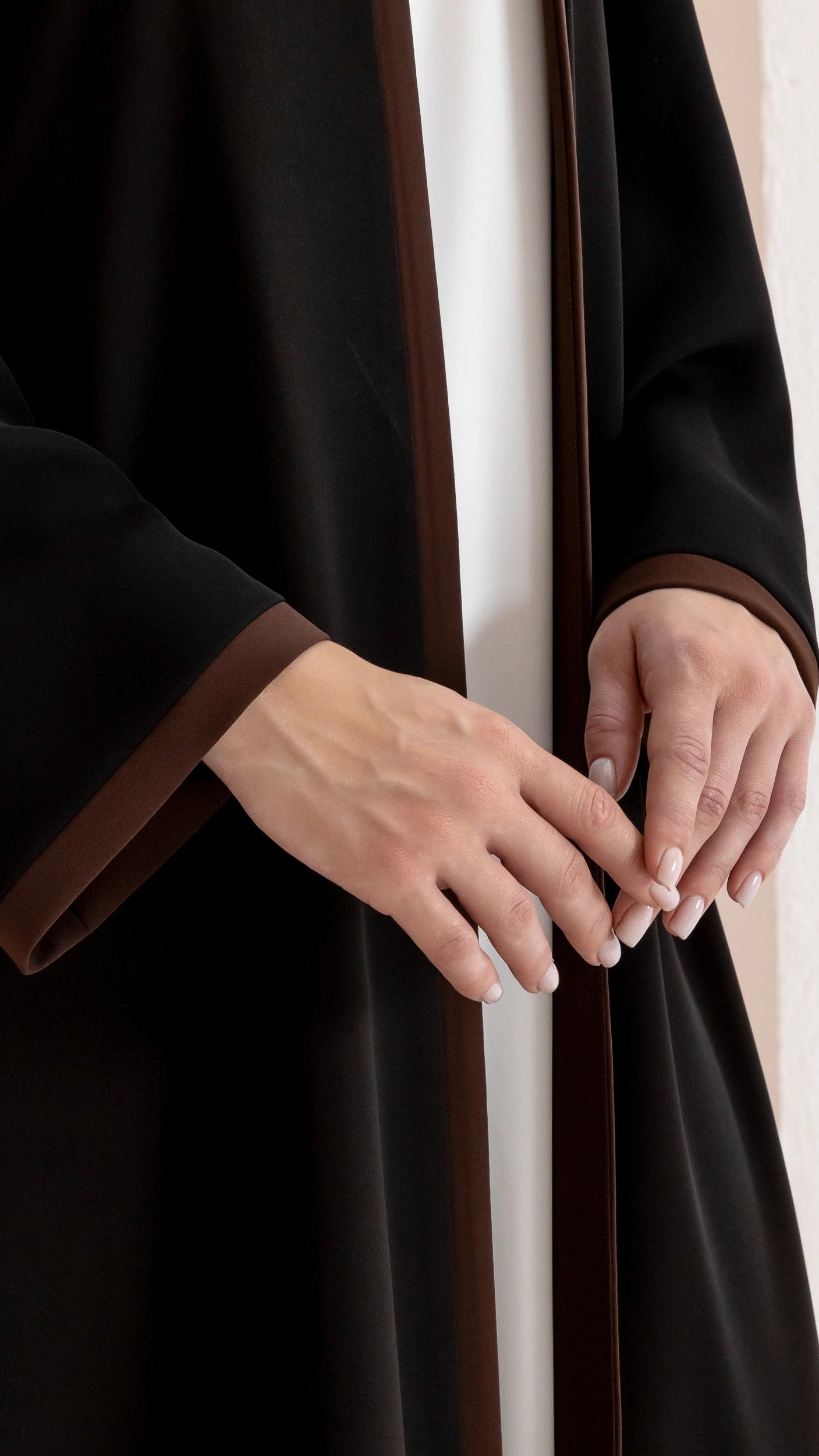 RUSMA Umber Trim luxury black abaya with warm brown edging close-up detail